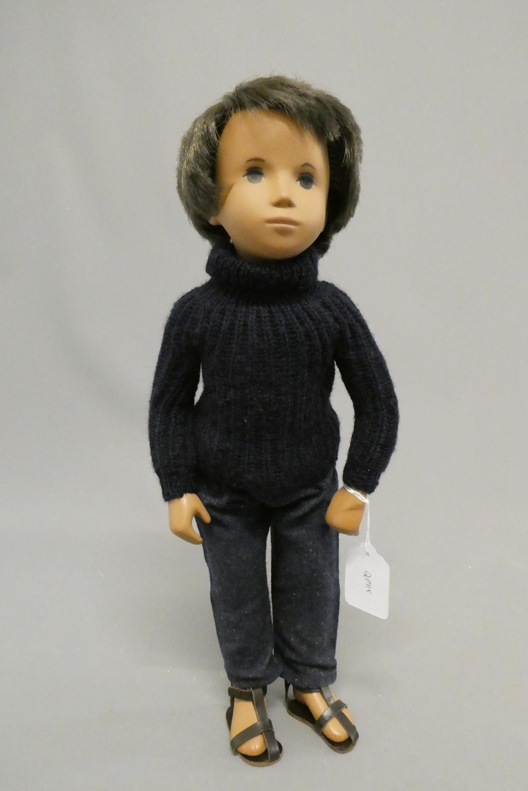 A Sasha boy doll, with brown hair and original outfit including leather sandals, 16" long (Est. plus Image
