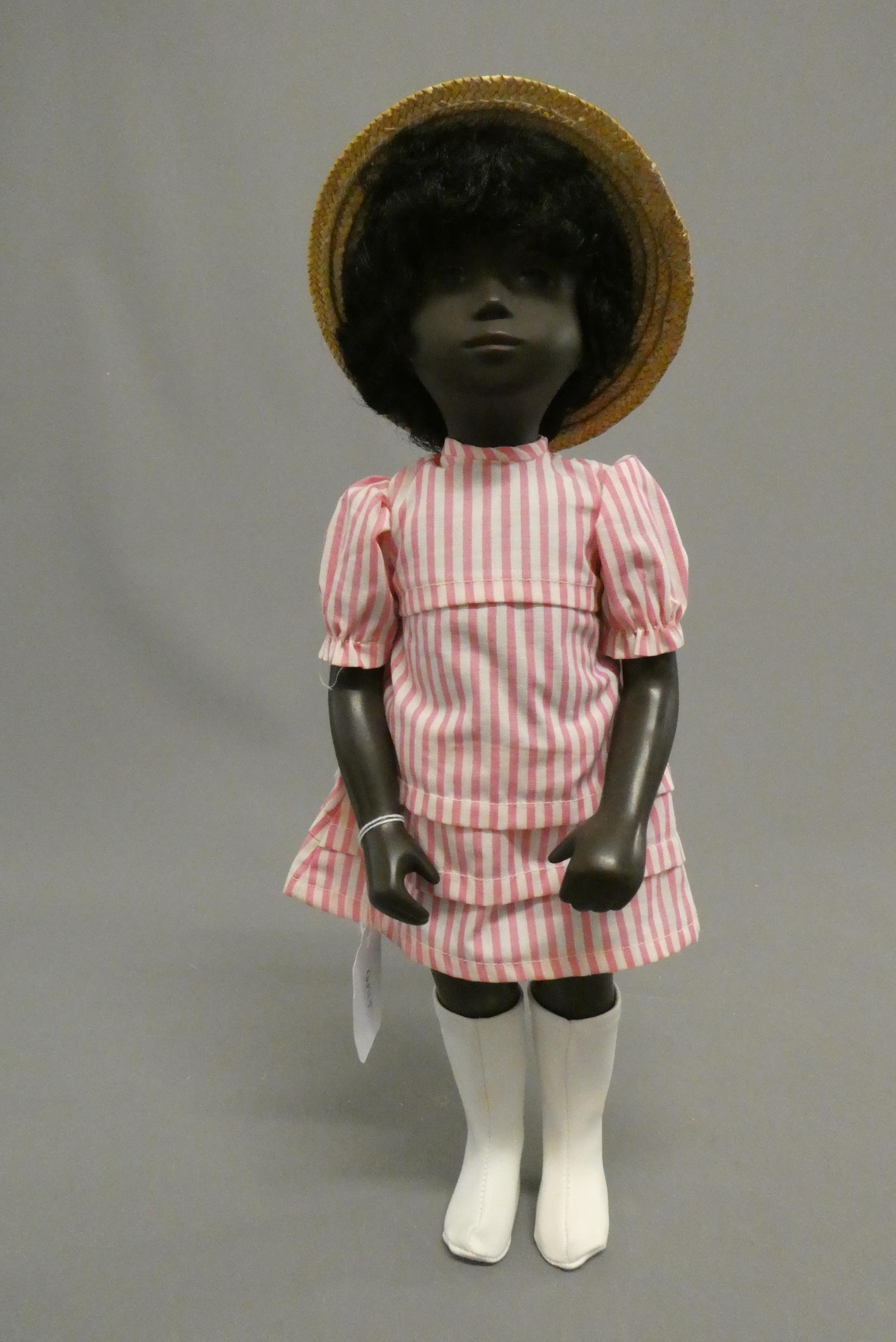 A Sasha girl doll, with black hair, pink striped dress and matching undergarments, leather boots and Image