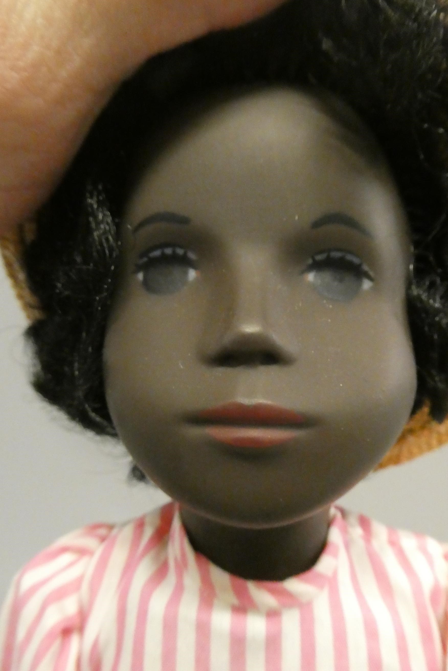 A Sasha girl doll, with black hair, pink striped dress and matching undergarments, leather boots and Image