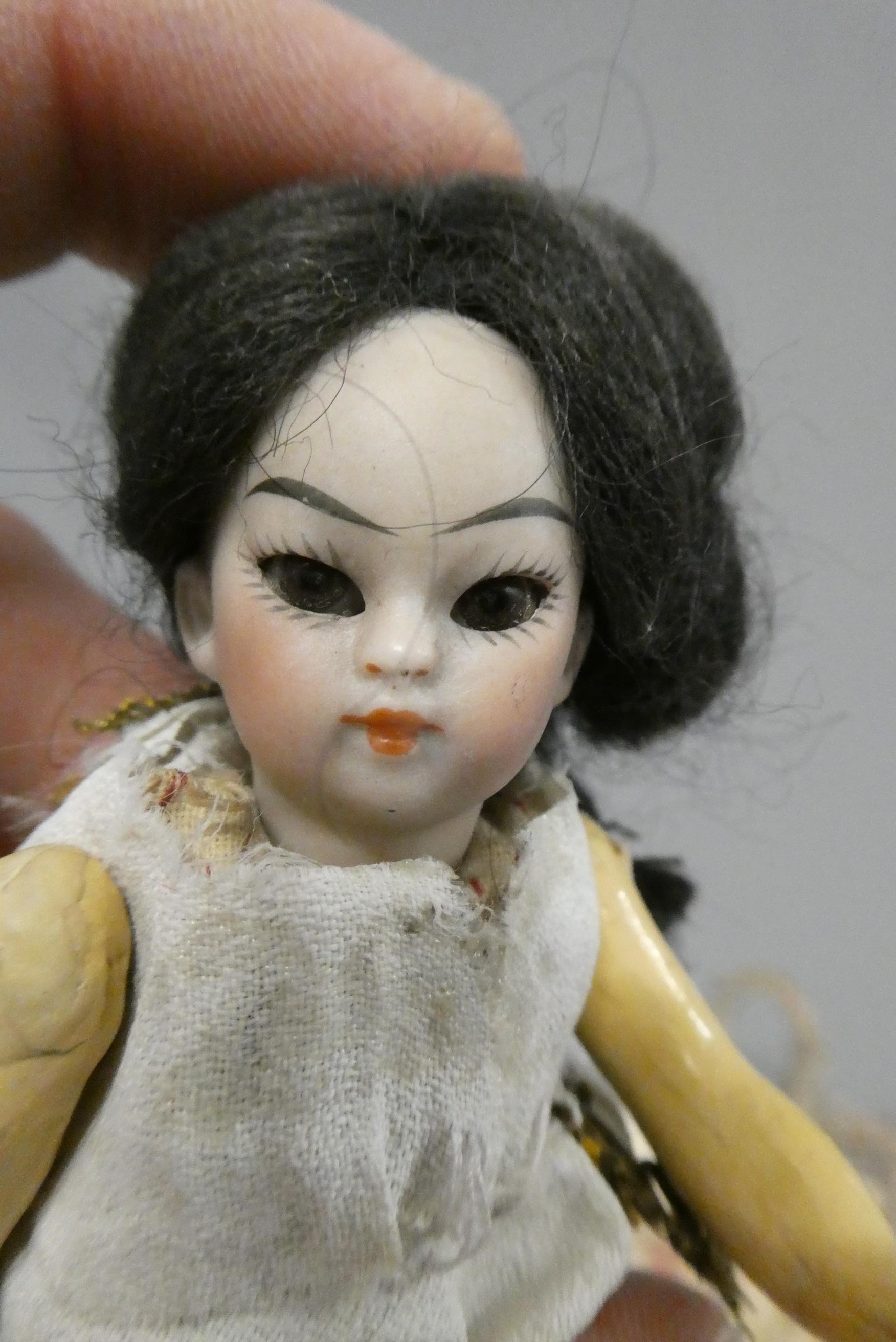 An oriental bisque socket head doll's house doll Image