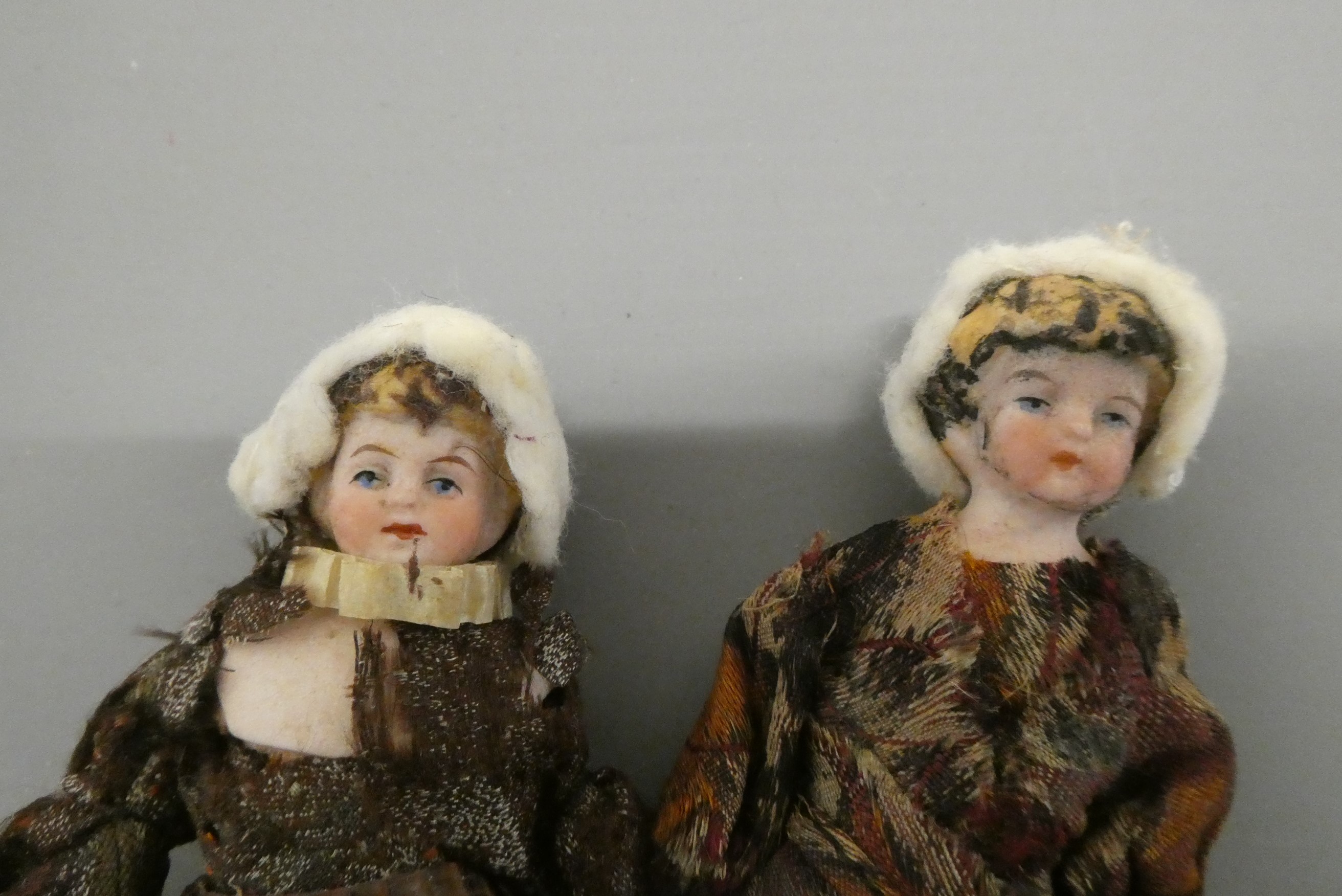 A pair of bisque shoulder head doll's house dolls, with moulded blond hair, painted features, bisque Image