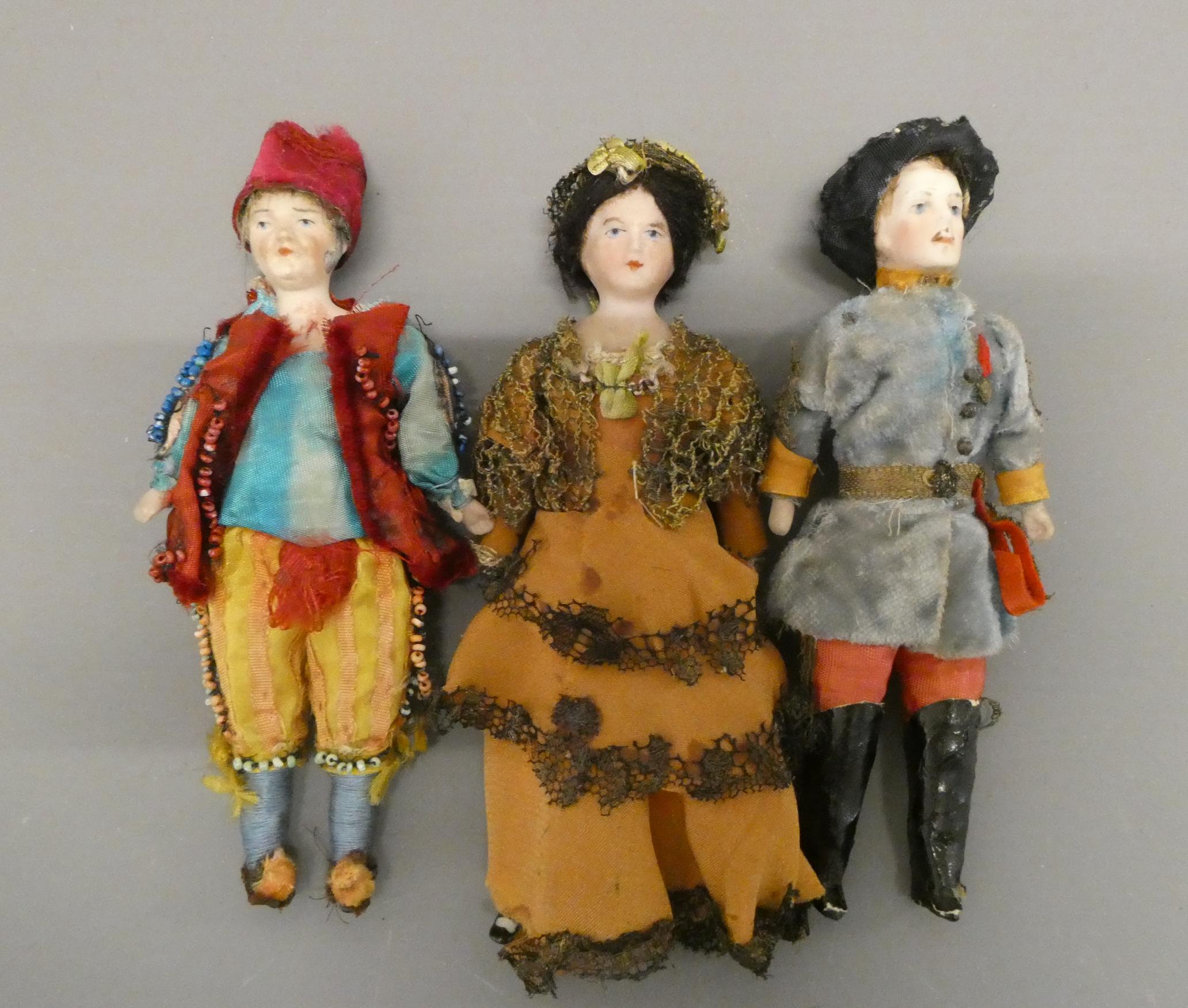 Three bisque shoulder head doll's house dolls, comprising two gentlemen and a lady, all with moulded Image