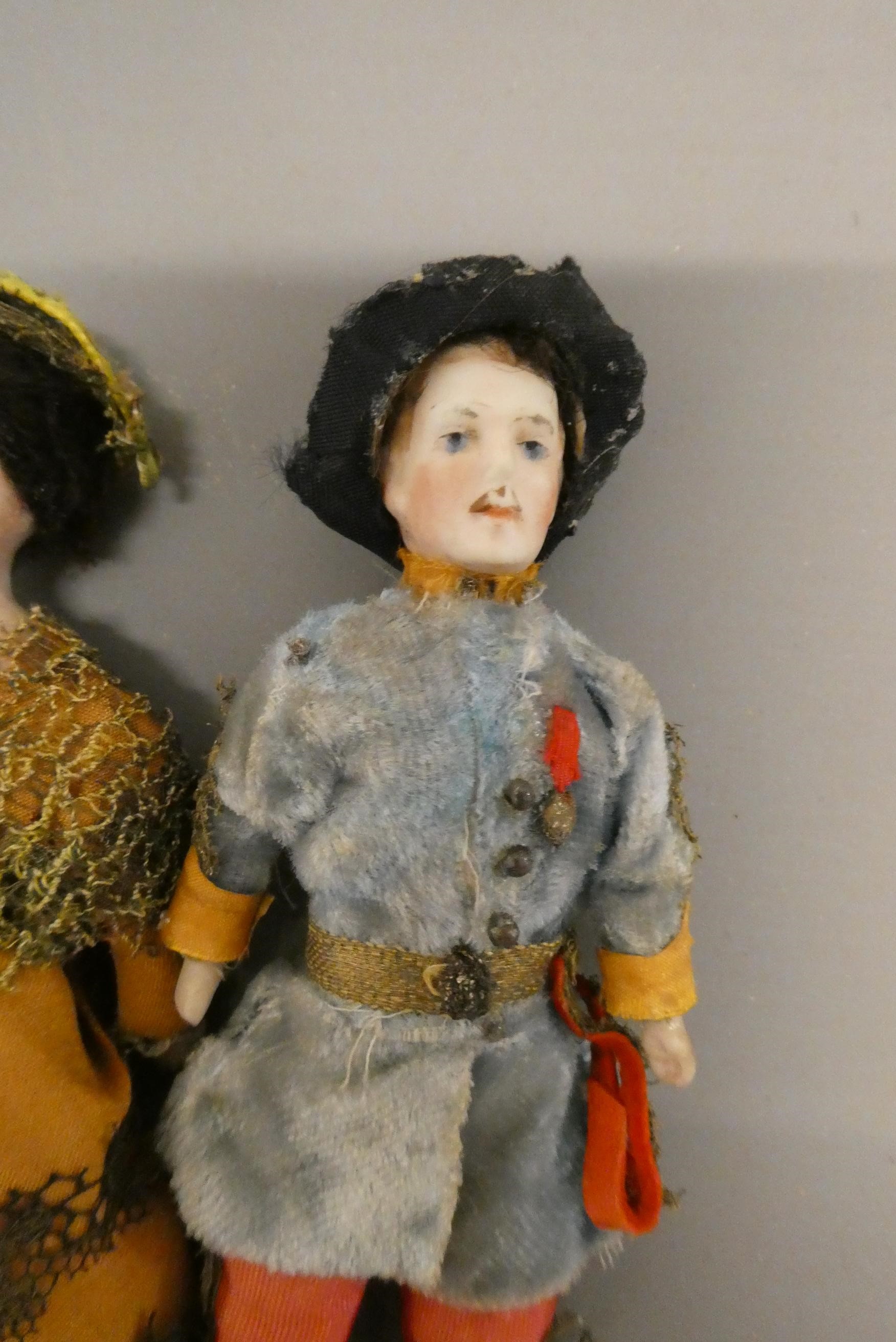 Three bisque shoulder head doll's house dolls, comprising two gentlemen and a lady, all with moulded Image