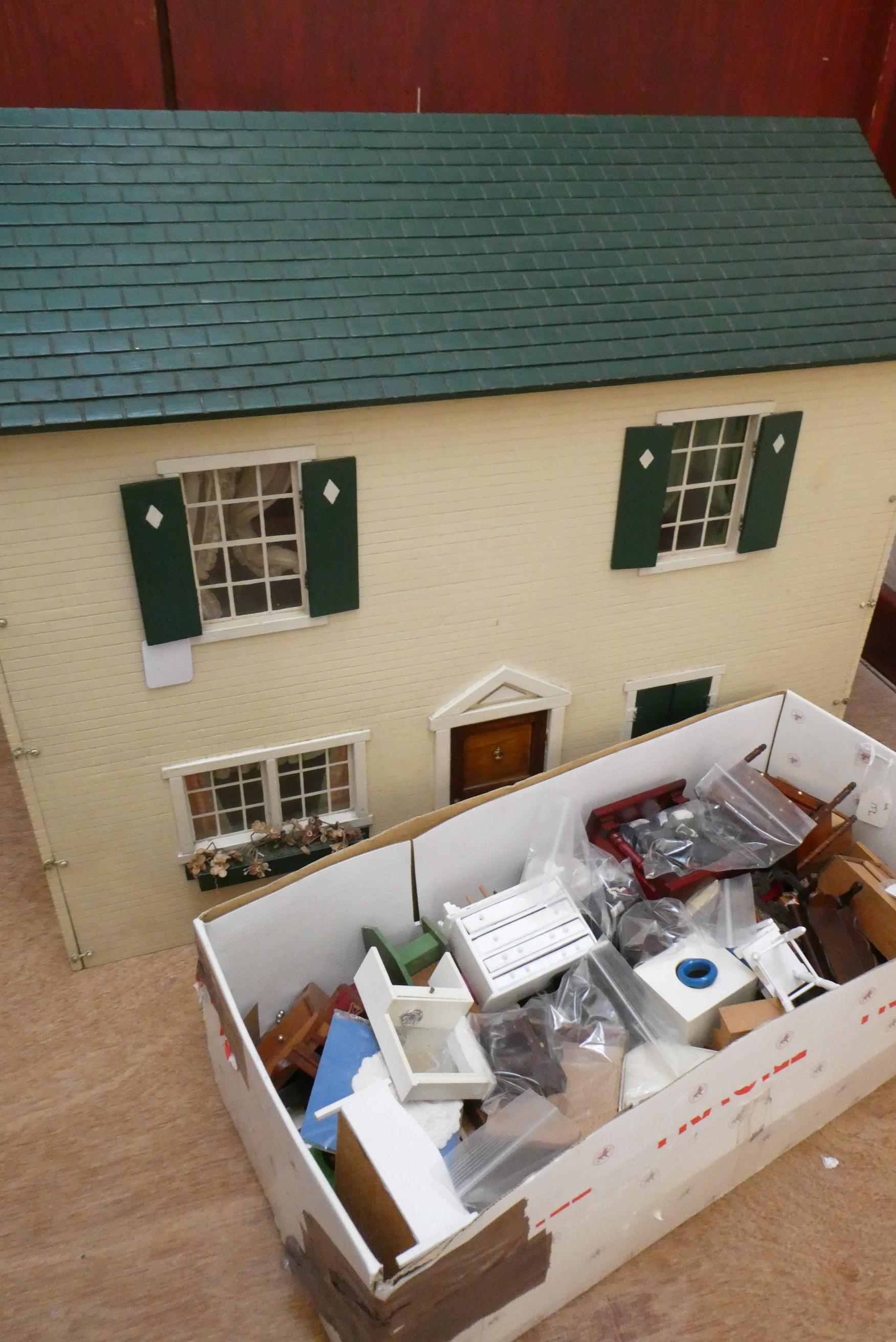 A "Tynietoy" 20th century dolls house together with a box of doll's house furniture and accessories Image