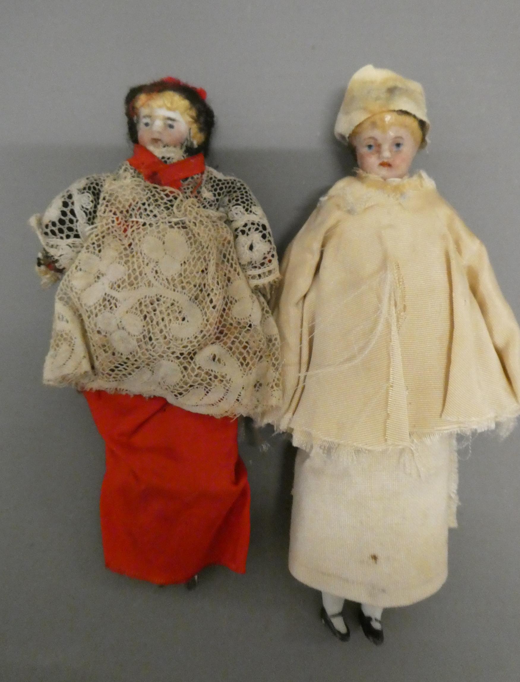 Two bisque shoulder head doll's house dolls, both with moulded hair, painted features and bisque Image