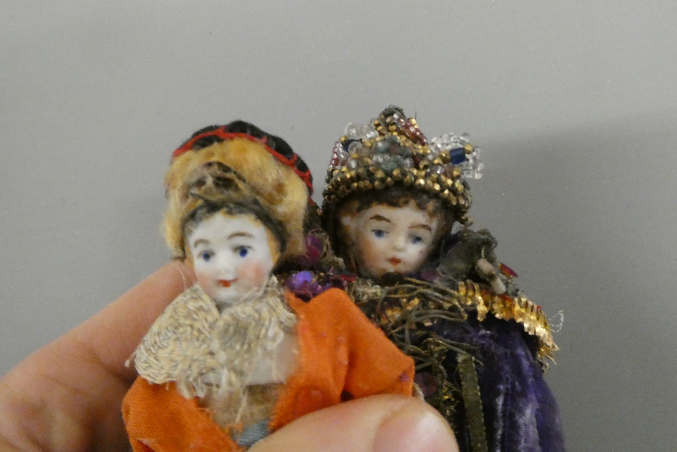 Two bisque shoulder head doll's house dolls, both with moulded hair, painted features and bisque Image