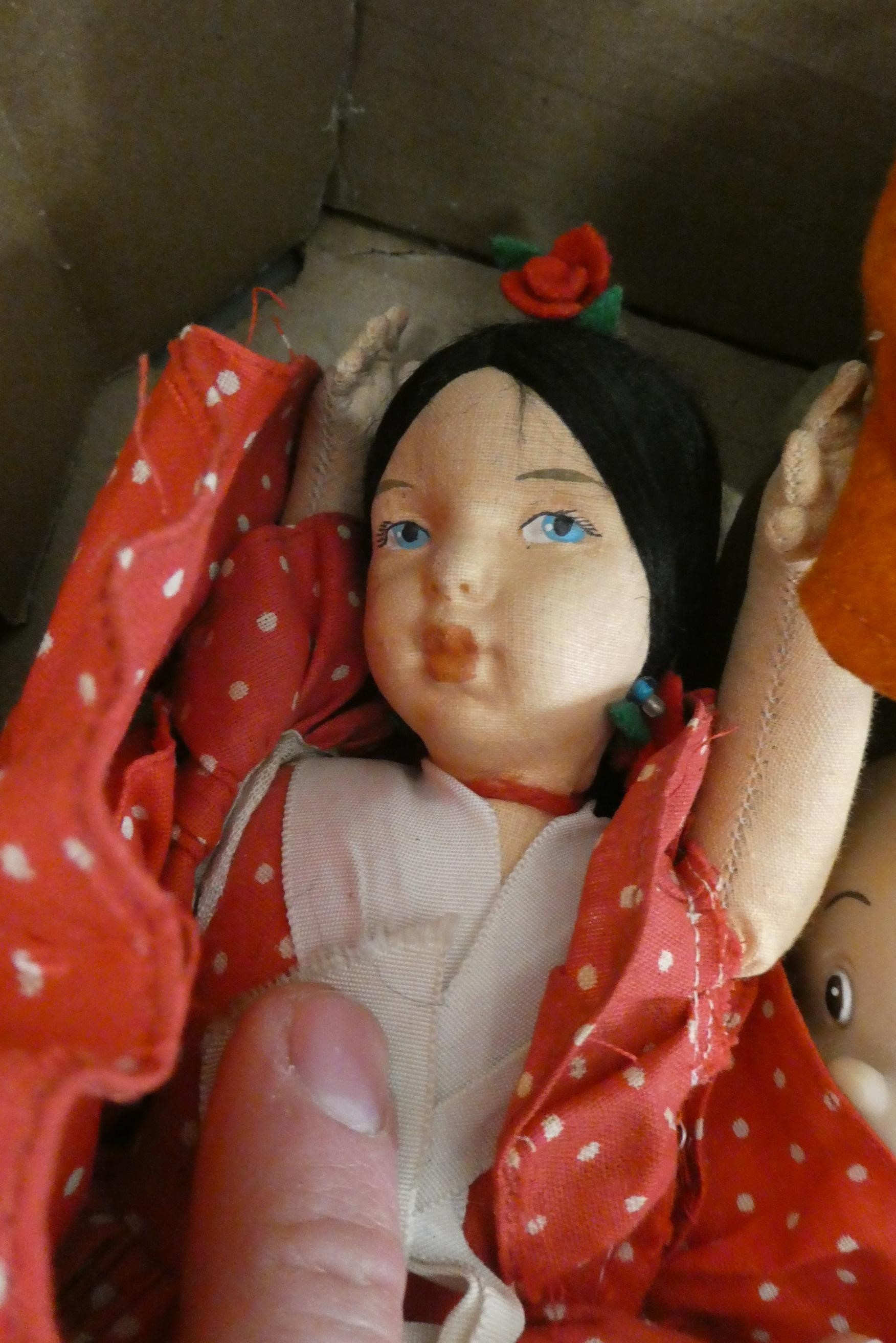 A box of mainly vintage dolls, including four Norah Wellings dolls and a reversible fabric doll Image