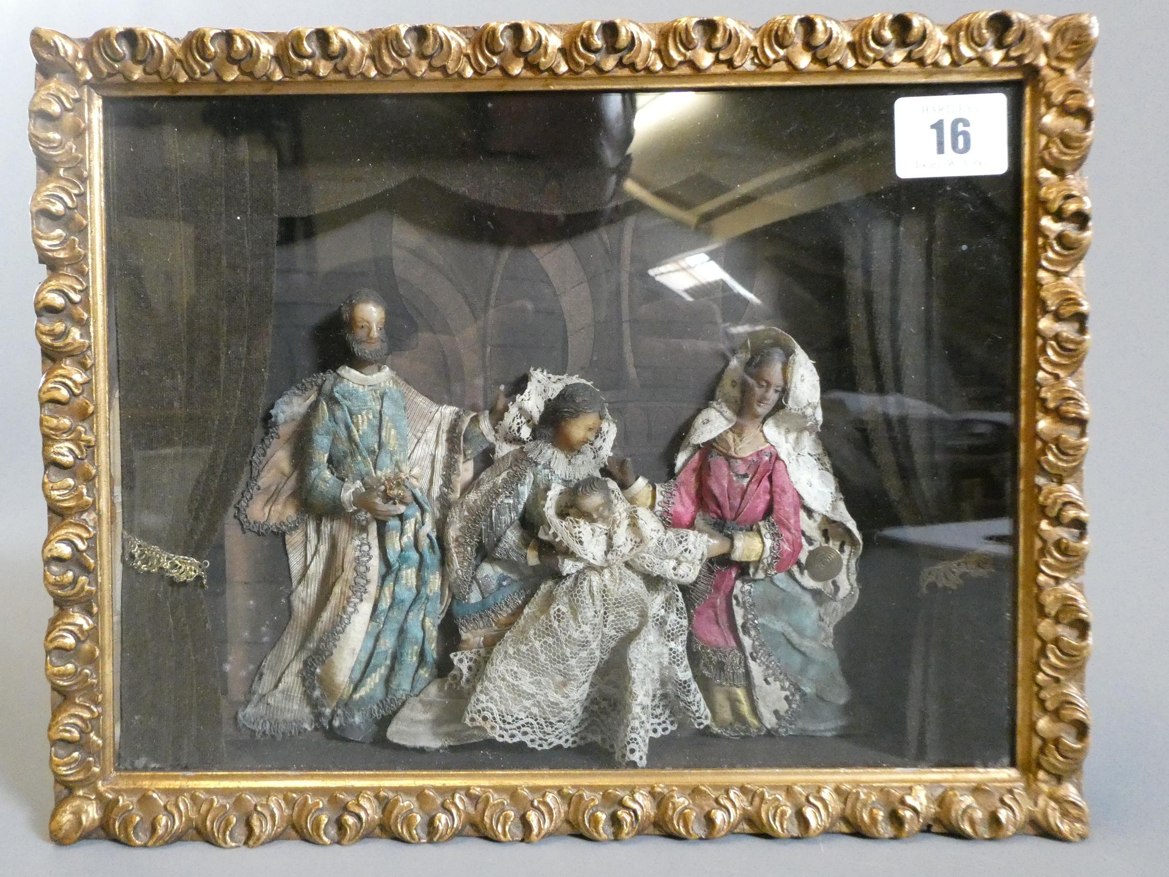A wax nativity diorama, the figures with moulded and painted wax heads and hands, and silk and lace Image