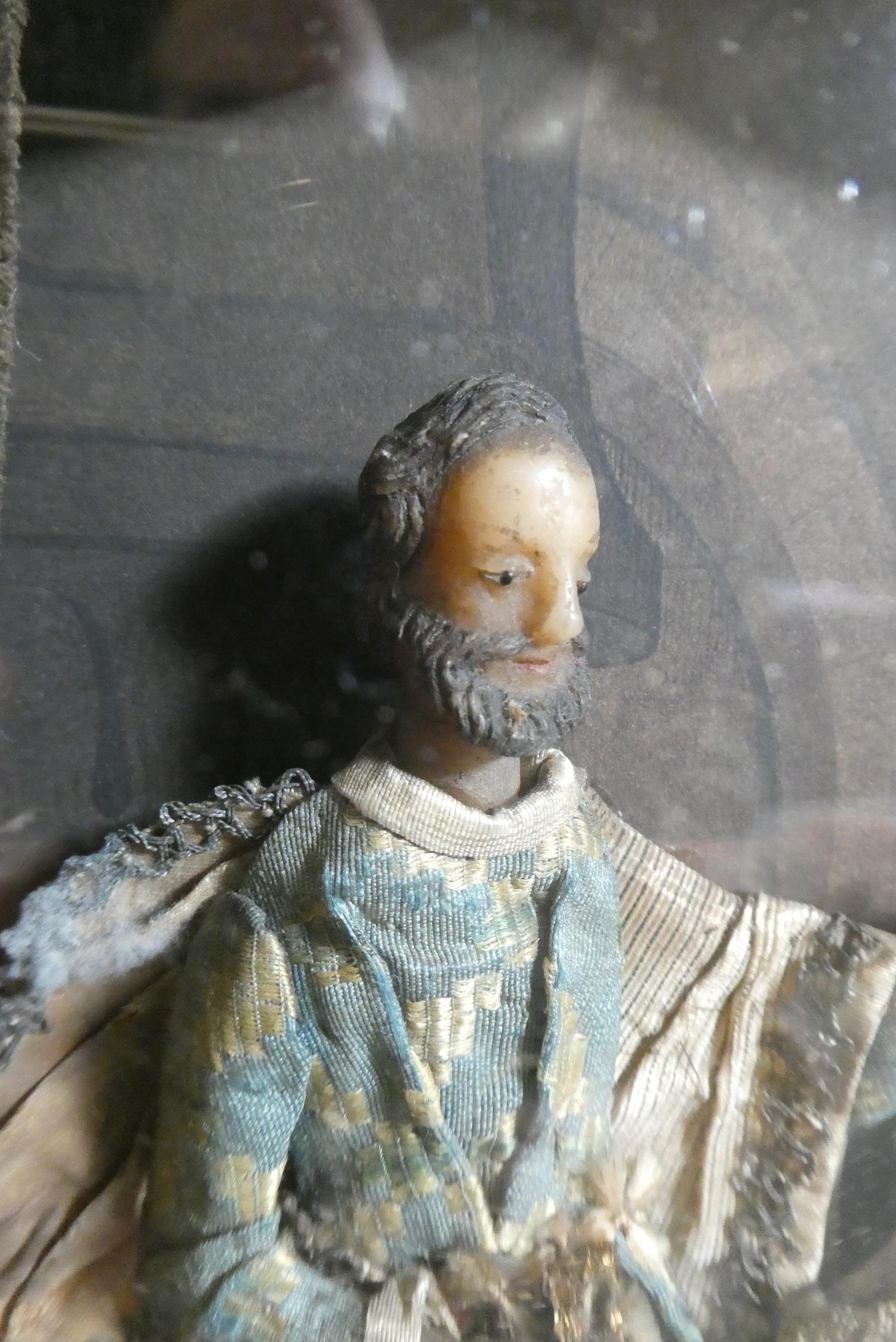 A wax nativity diorama, the figures with moulded and painted wax heads and hands, and silk and lace Image