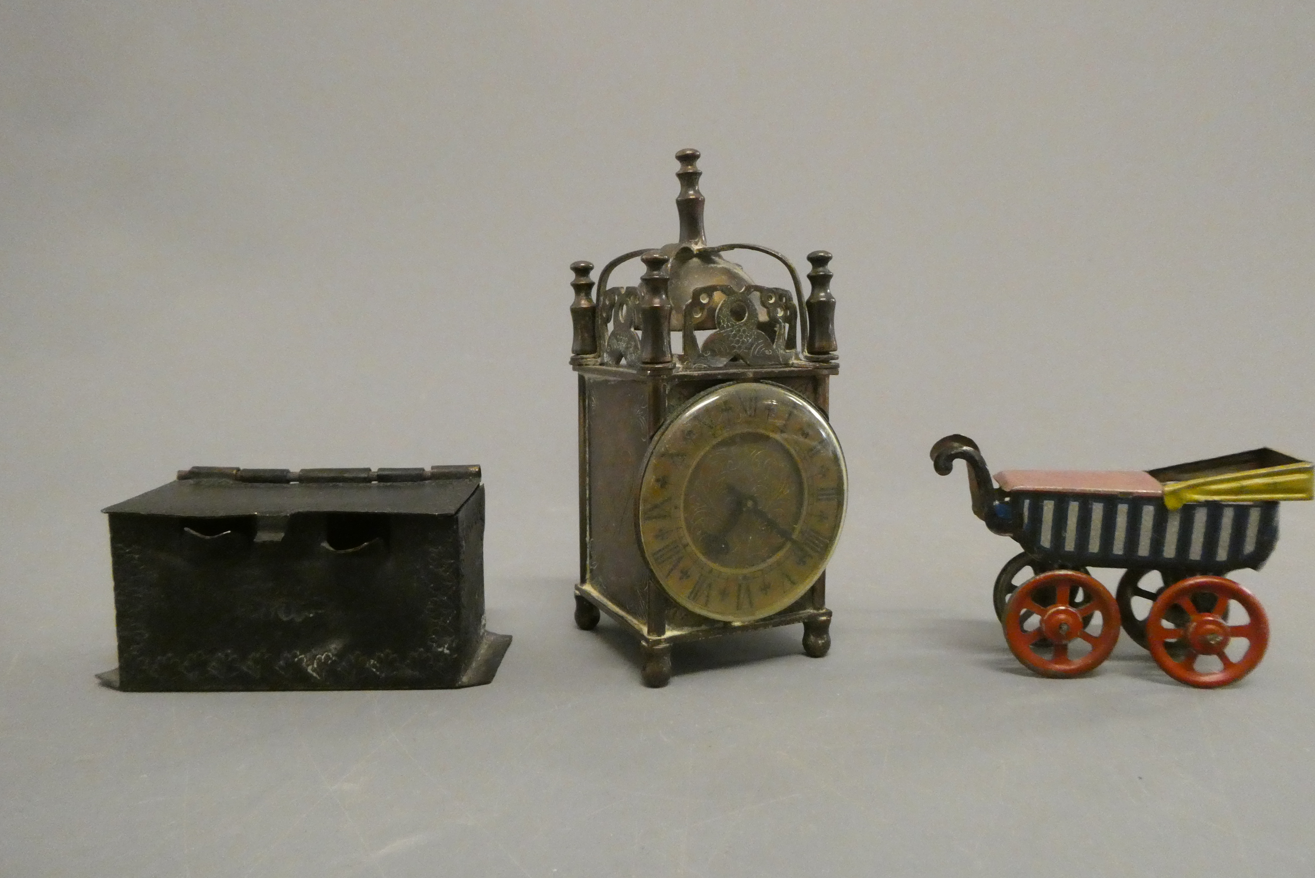 Three doll's house items, comprising a 3 3/4" British made brass lantern clock, a 2 3/8" tinplate Image