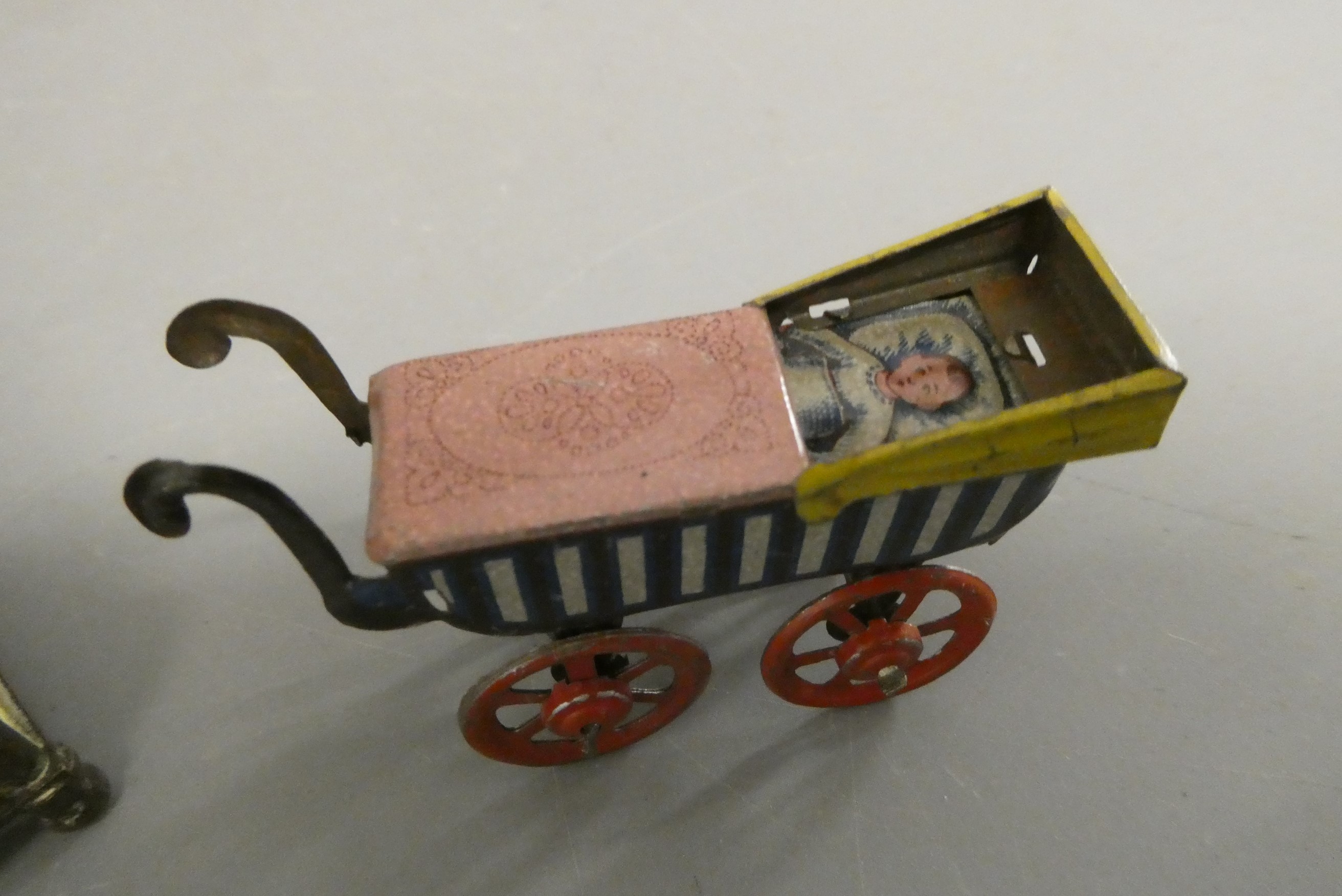 Three doll's house items, comprising a 3 3/4" British made brass lantern clock, a 2 3/8" tinplate Image
