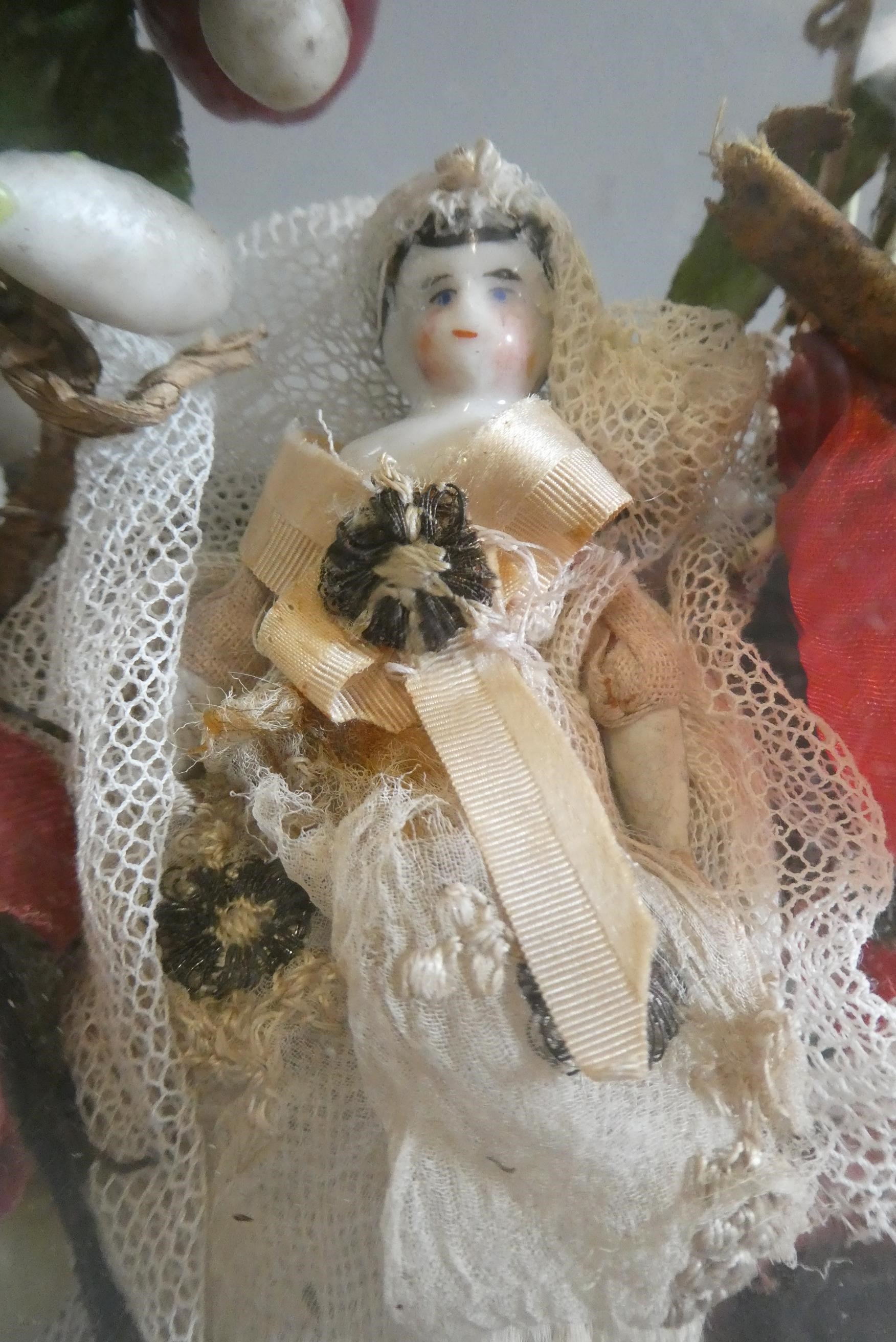 A ceramic shoulder head doll and wax fruit diorama Image