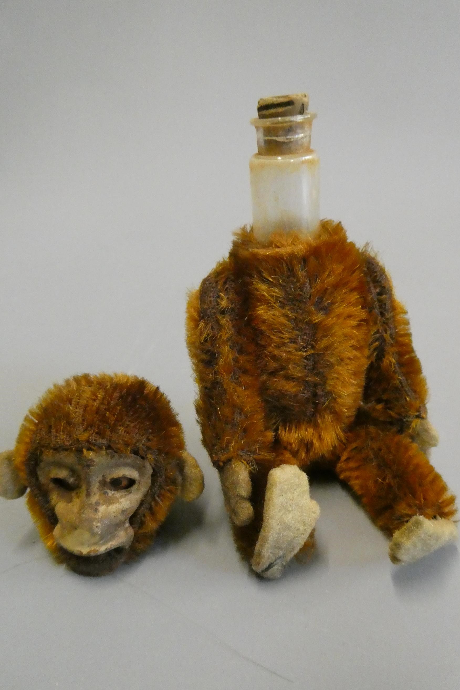 Schuco monkey perfume bottle, with brown plush, felt ears, feet and hands, jointed body and internal Image