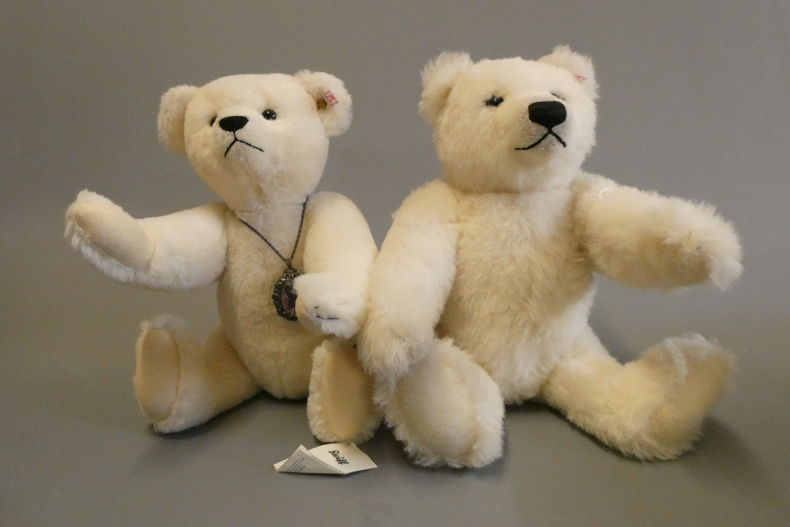 Two white Steiff bears, comprising a 13 3/4" Margarete Steiff bear with locket, and a 15 1/2" Image