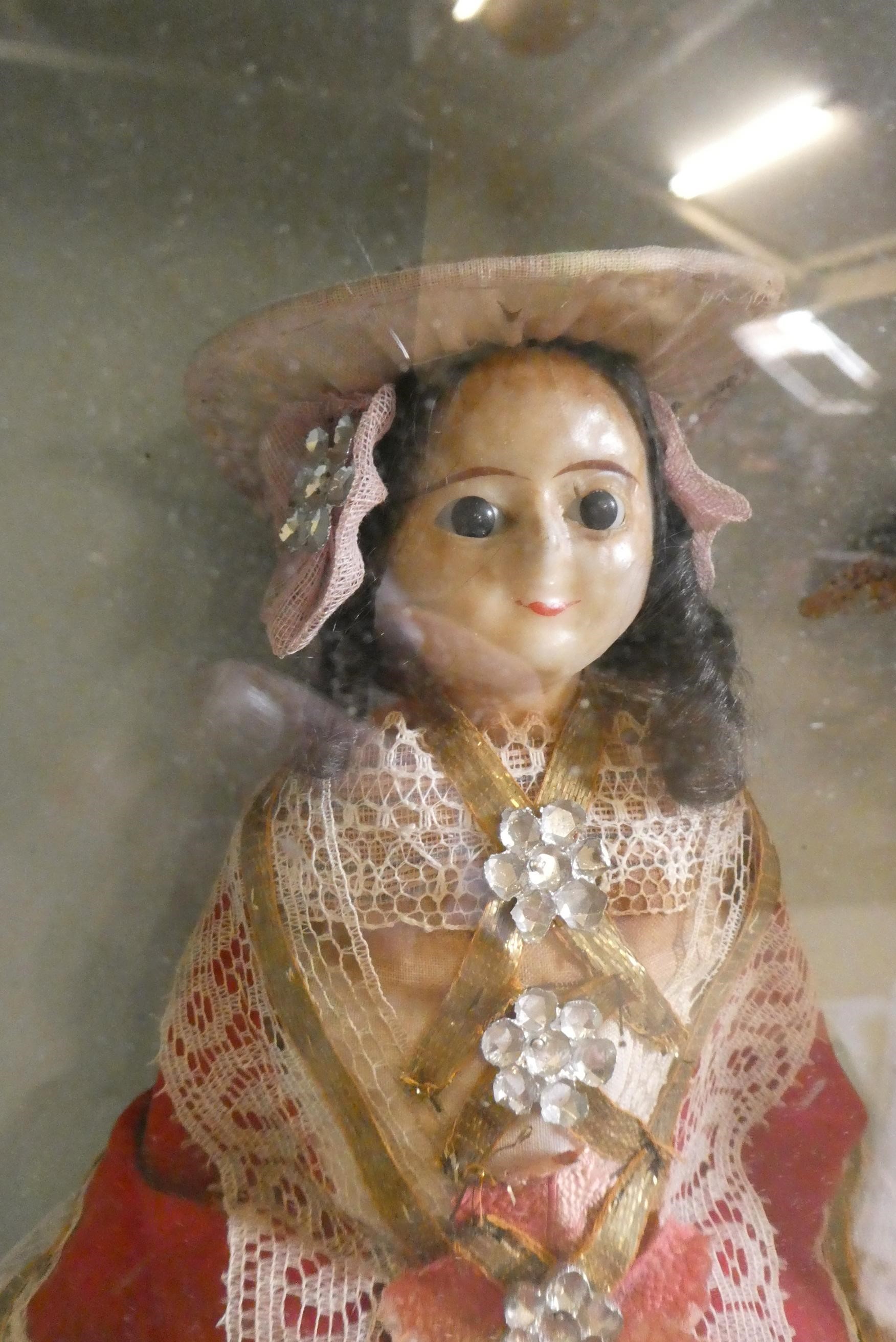 A wax head doll and taxidermy diorama Image
