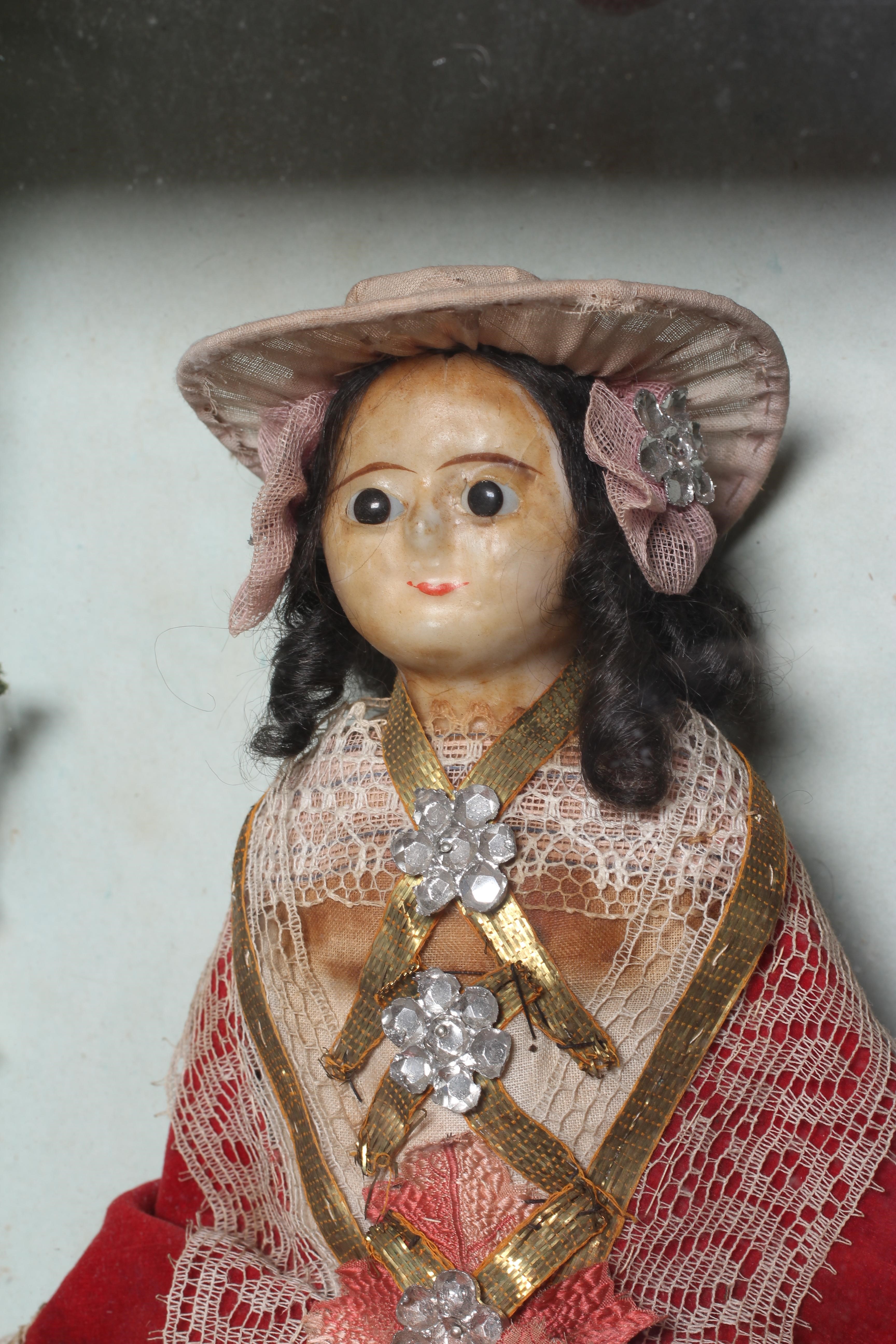 A wax head doll and taxidermy diorama Image