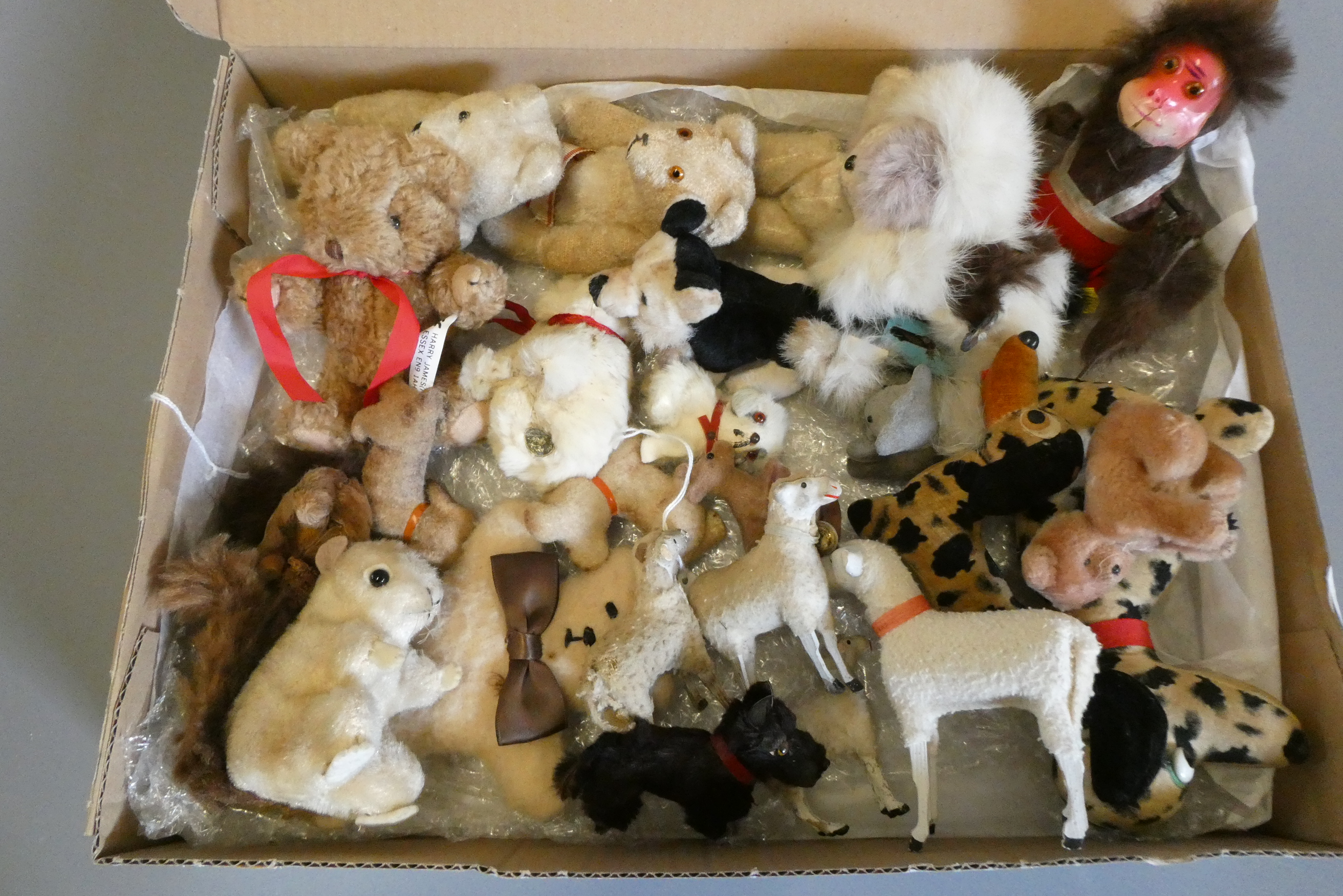 A collection of vintage plush toys including two clockwork toys, a German sheep and three lambs with Image