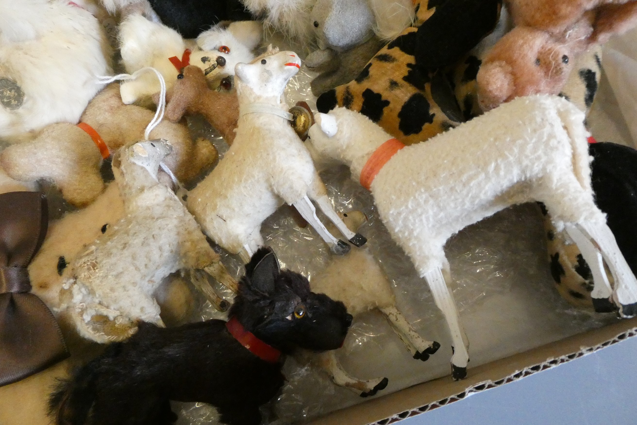 A collection of vintage plush toys including two clockwork toys, a German sheep and three lambs with Image