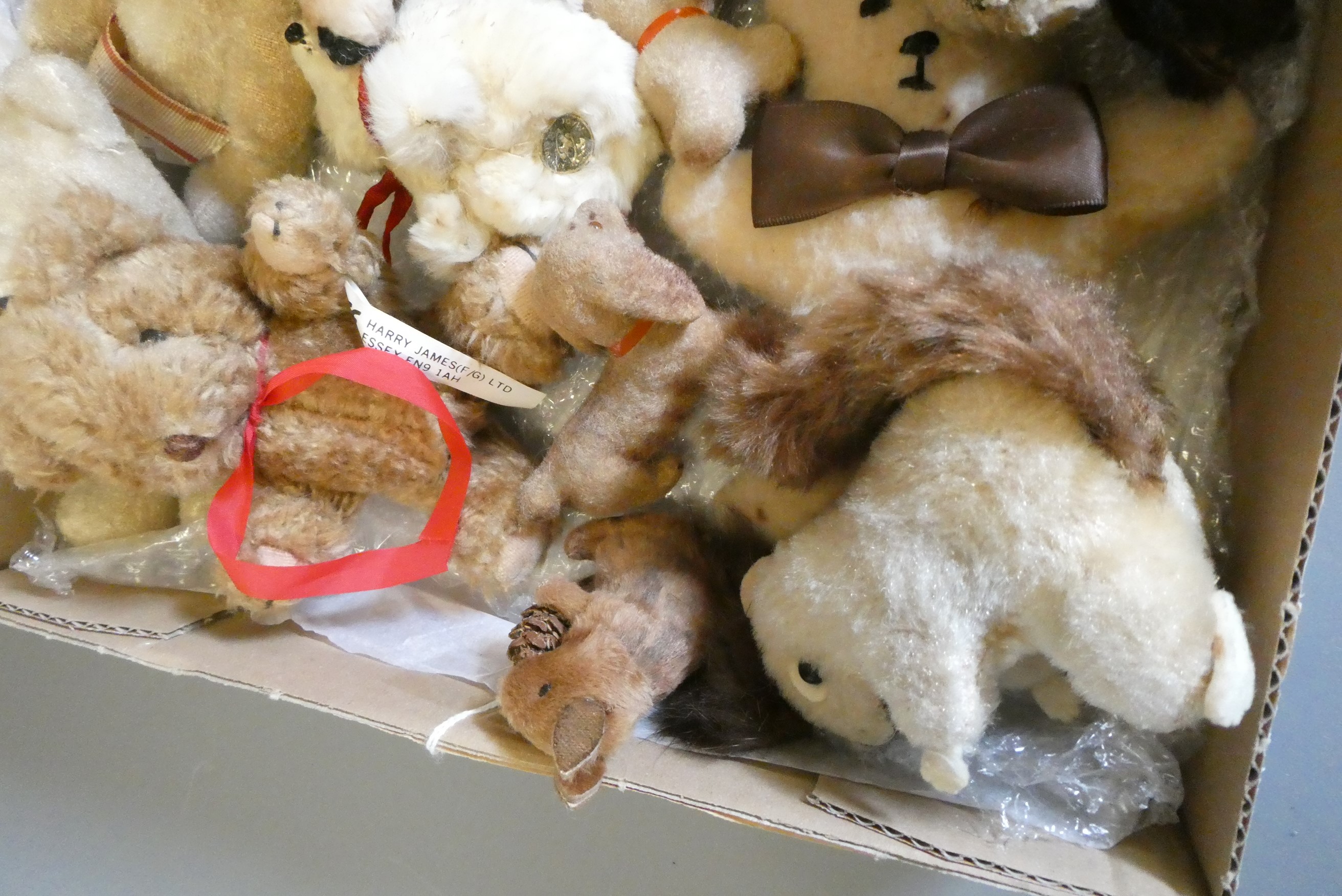 A collection of vintage plush toys including two clockwork toys, a German sheep and three lambs with Image