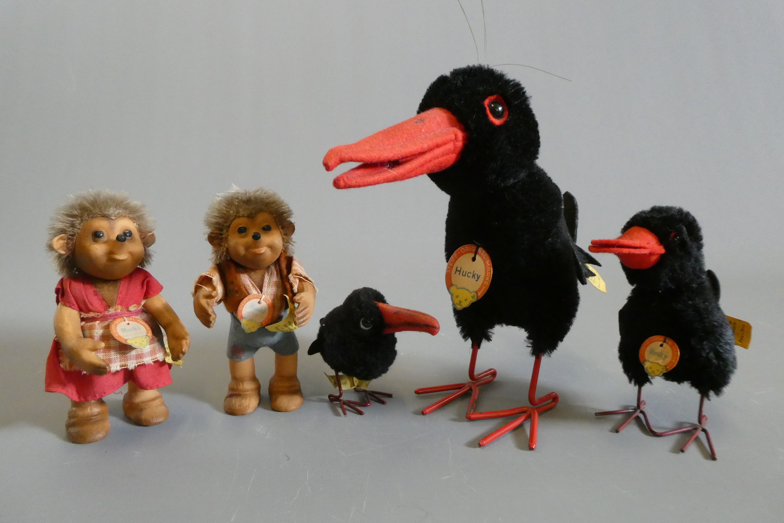 Five Steiff plush animals, comprising three Hucky birds of varied sizes with wire legs and labels, a Image