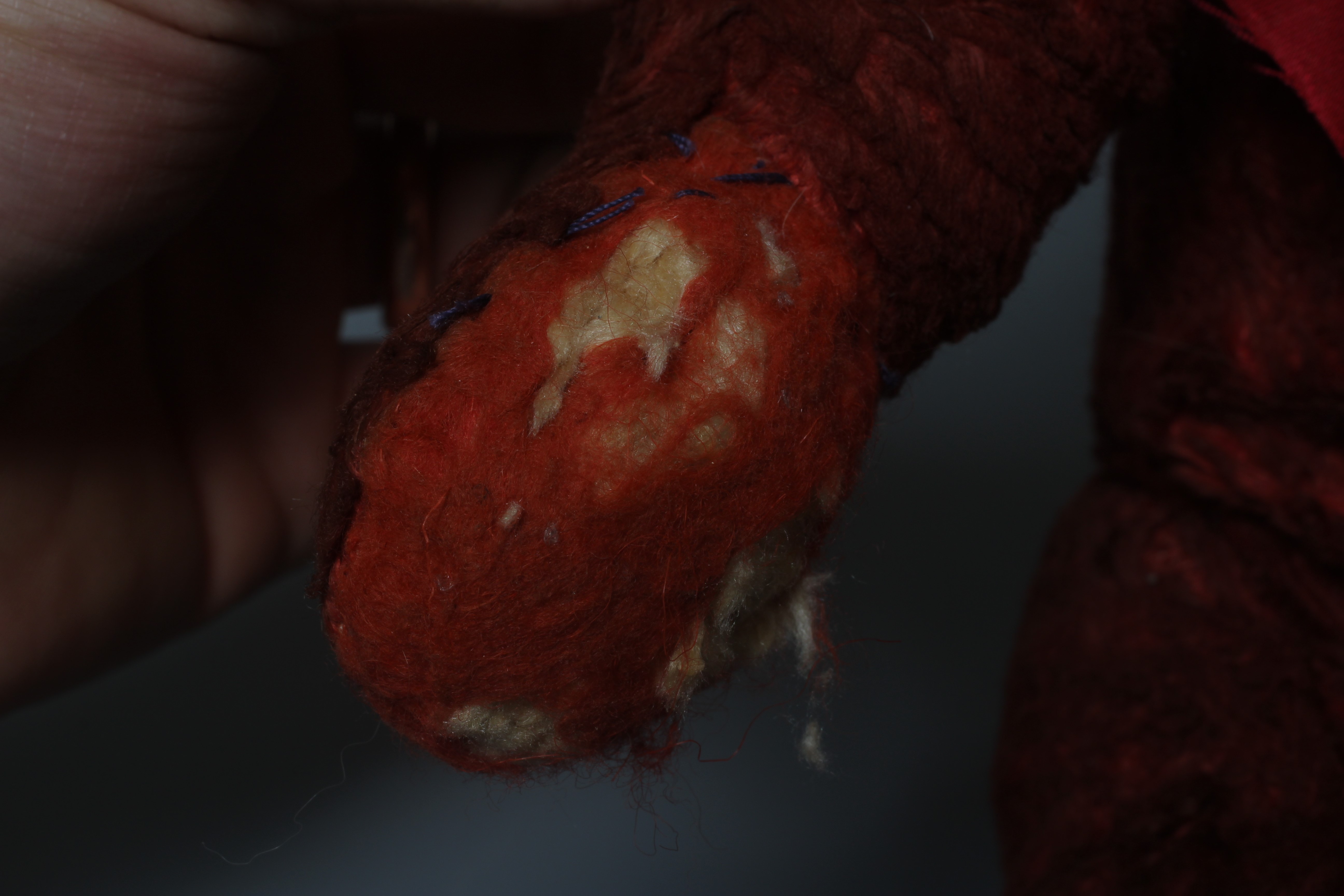 A pre-war red art silk teddy bear, possibly Chad Valley, with sewn nose, red glass eyes and felt Image