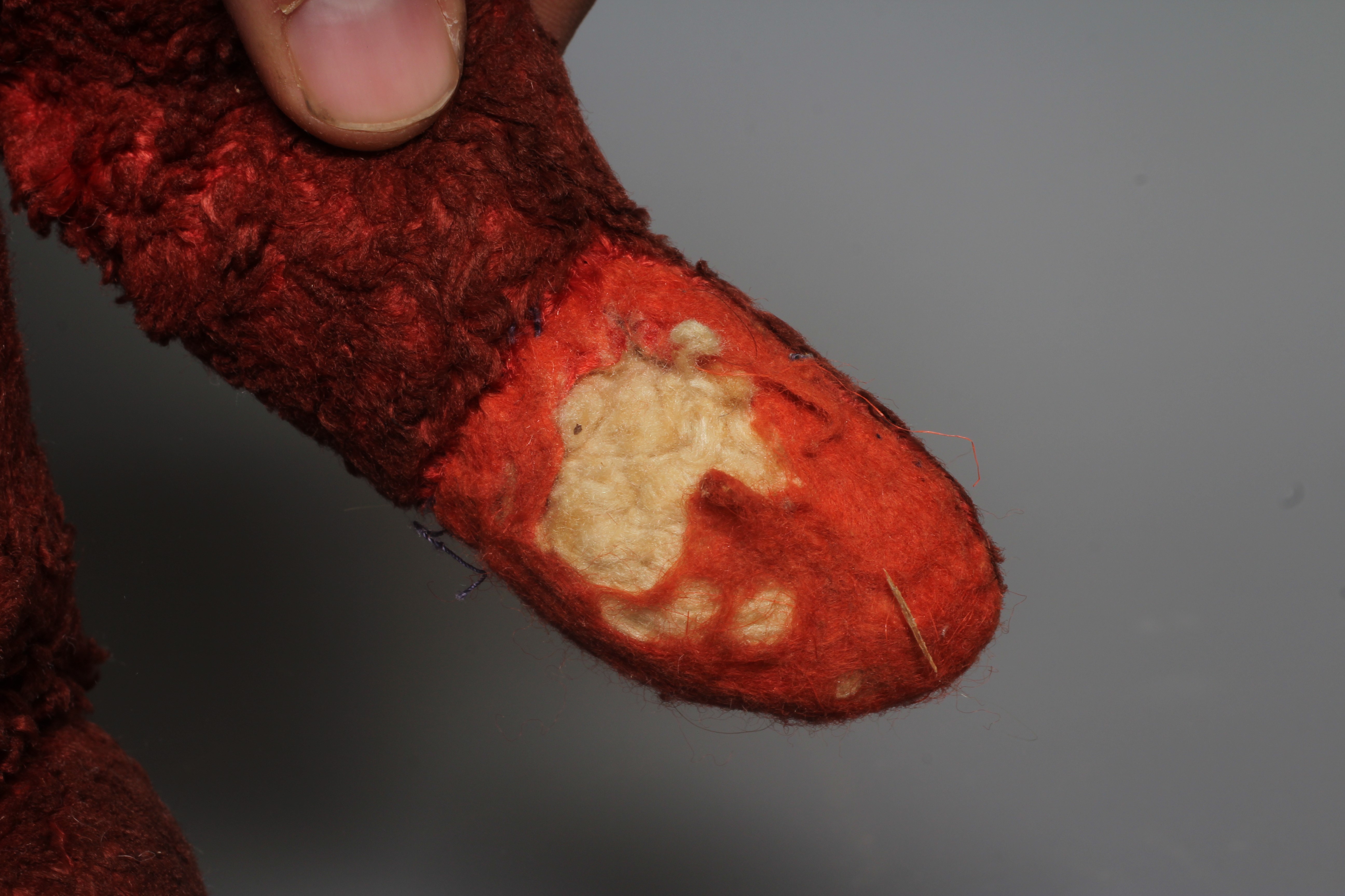 A pre-war red art silk teddy bear, possibly Chad Valley, with sewn nose, red glass eyes and felt Image