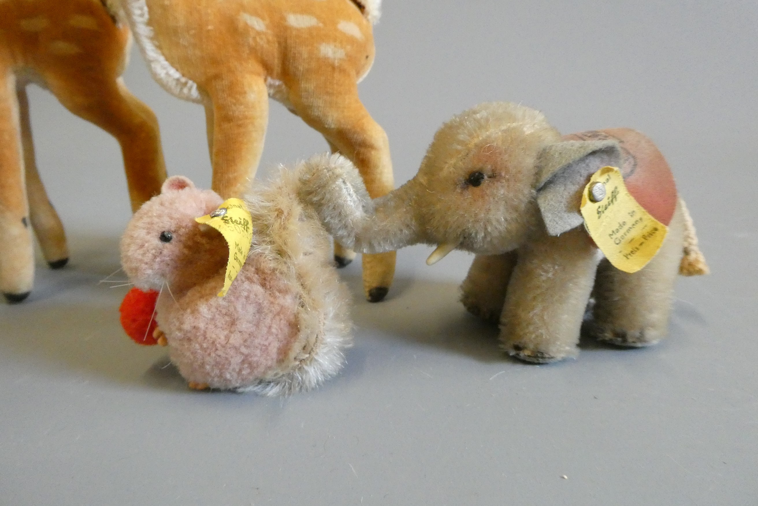 Six Steiff plush animals comprising two bambi's, two elephants, a Leo lion and a small squirrel Image