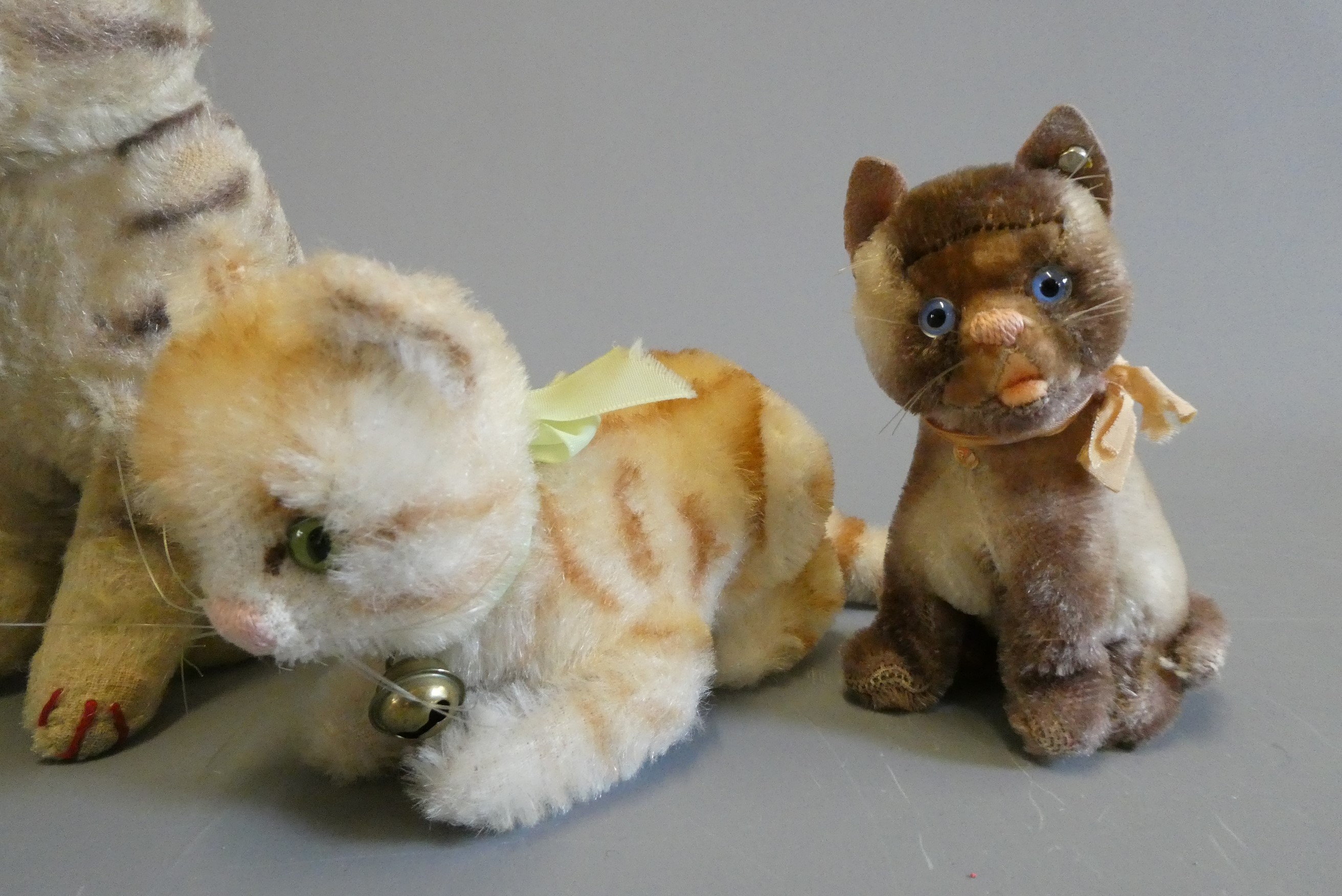 Five Steiff cats, most vintage and four with ear buttons, largest 6 3/8" tall (Est. plus 24% buyer's Image