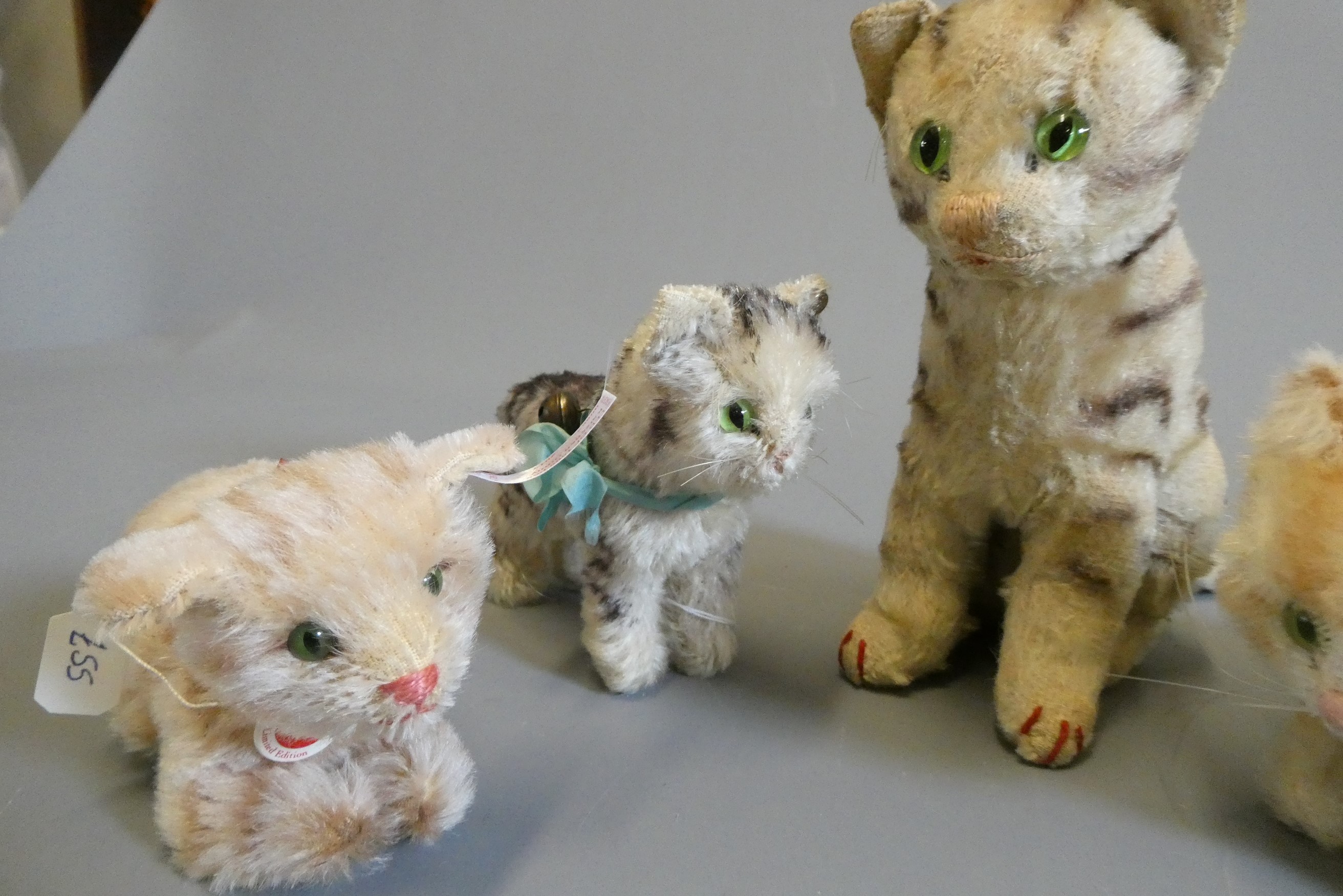 Five Steiff cats, most vintage and four with ear buttons, largest 6 3/8" tall (Est. plus 24% buyer's Image