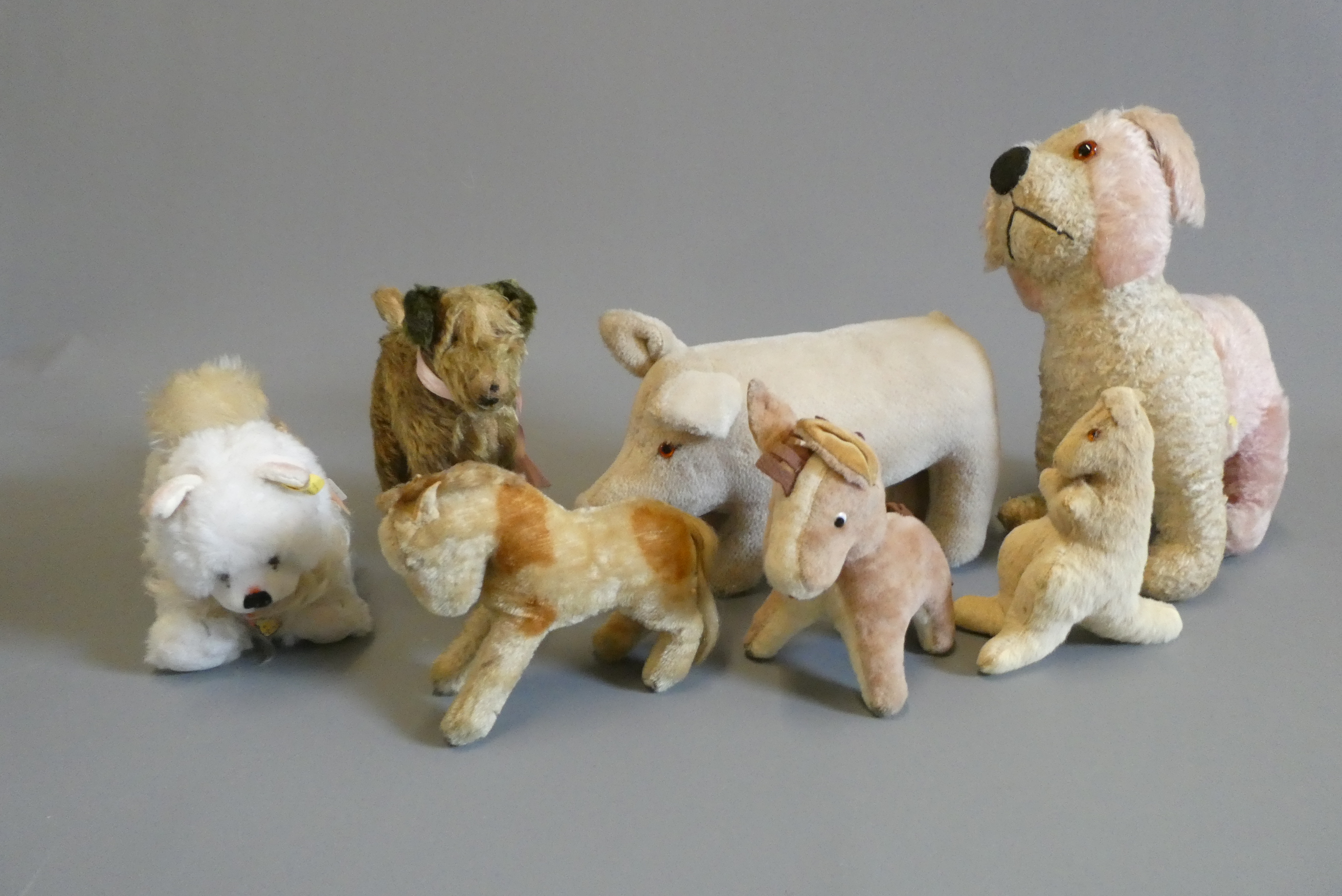 Seven vintage plush toys, including a Steiff Blanko and a Merrythought pig (Est. plus 24% buyer's Image