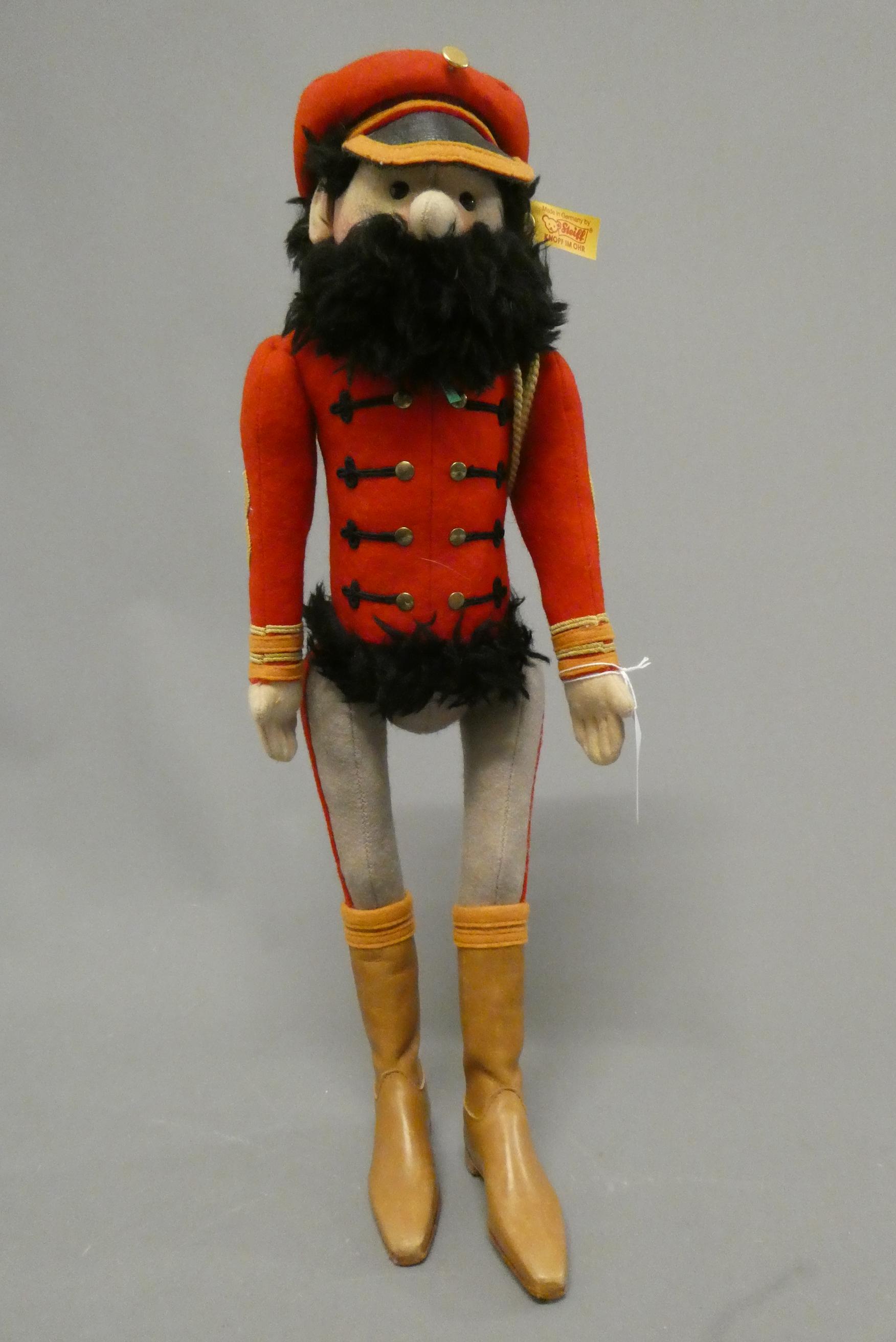 A Steiff Hungarian cavalry man, in red tunic with hat and beard, with ear button and label, 17 1/2" Image