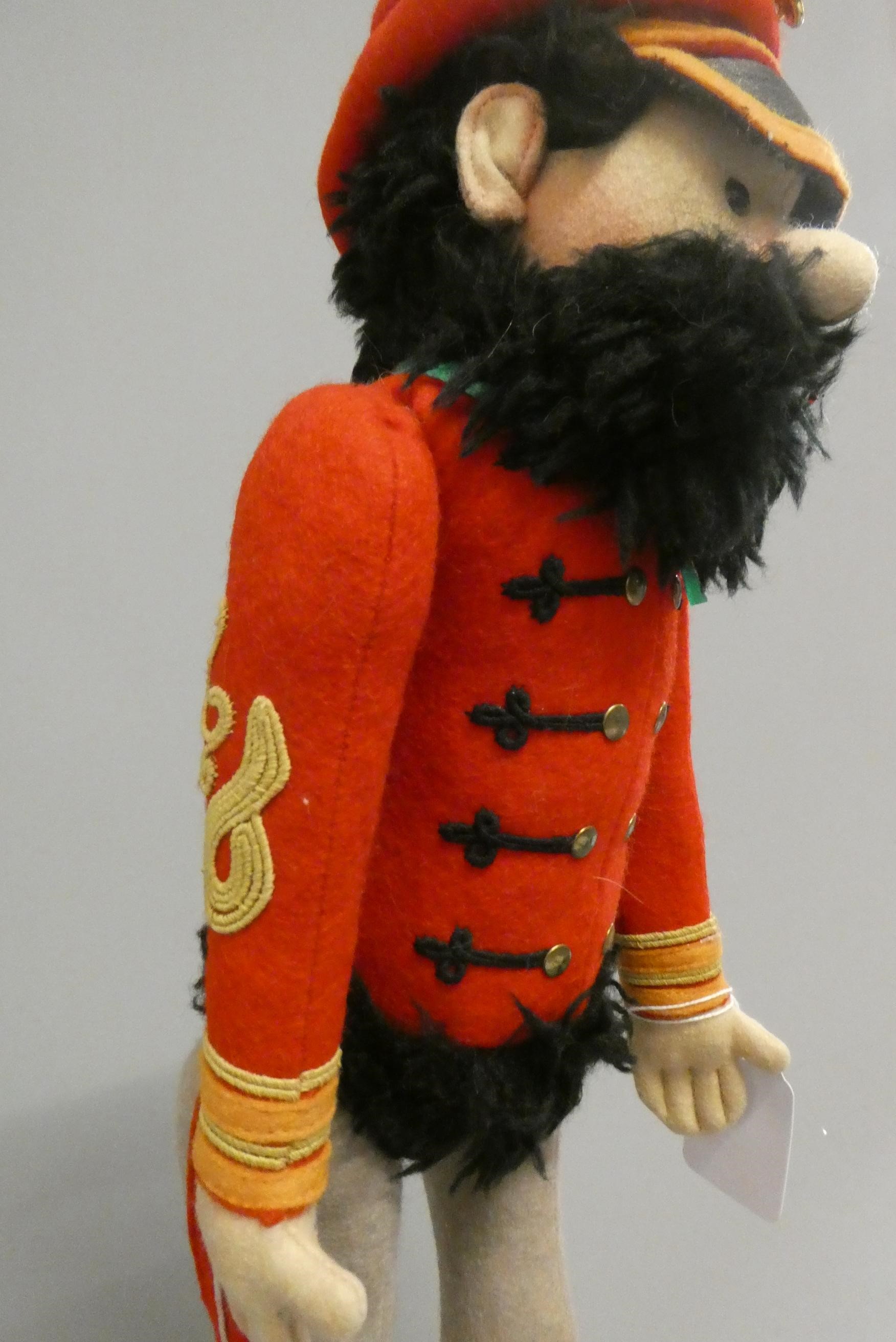 A Steiff Hungarian cavalry man, in red tunic with hat and beard, with ear button and label, 17 1/2" Image