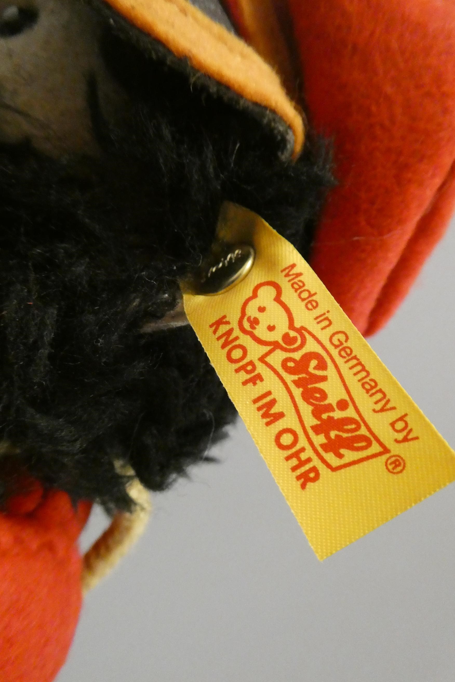 A Steiff Hungarian cavalry man, in red tunic with hat and beard, with ear button and label, 17 1/2" Image