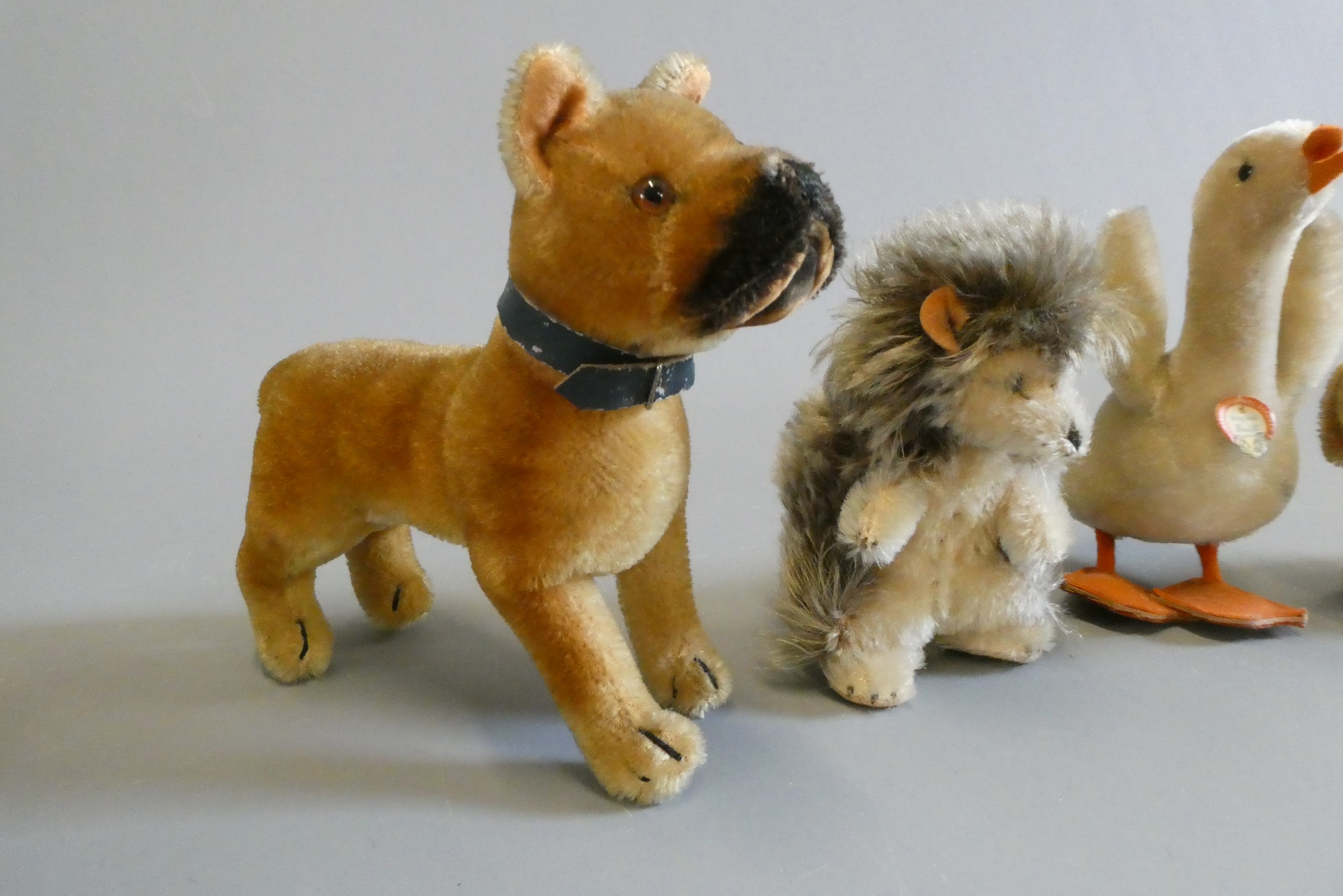 Four Steiff animals, comprising a goose, a hedgehog, a dog and Bazi (Est. plus 24% buyer's premium Image