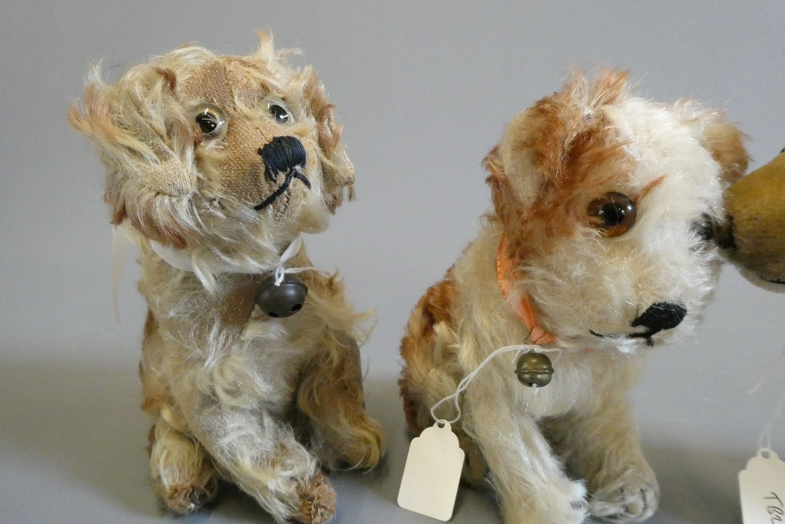 Three vintage plush dogs, including one with a Steiff button to its ear, others possibly by the same Image