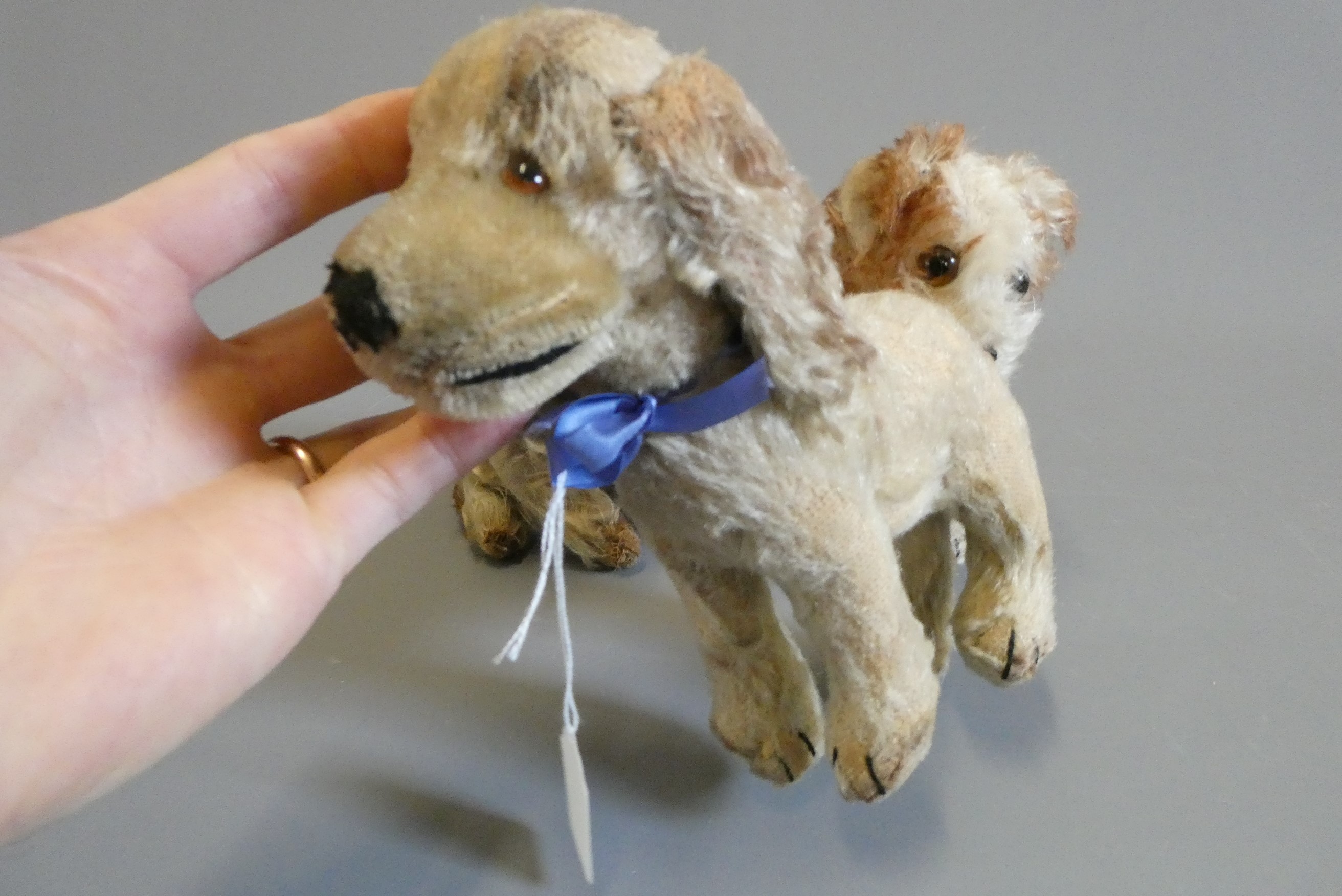 Three vintage plush dogs, including one with a Steiff button to its ear, others possibly by the same Image