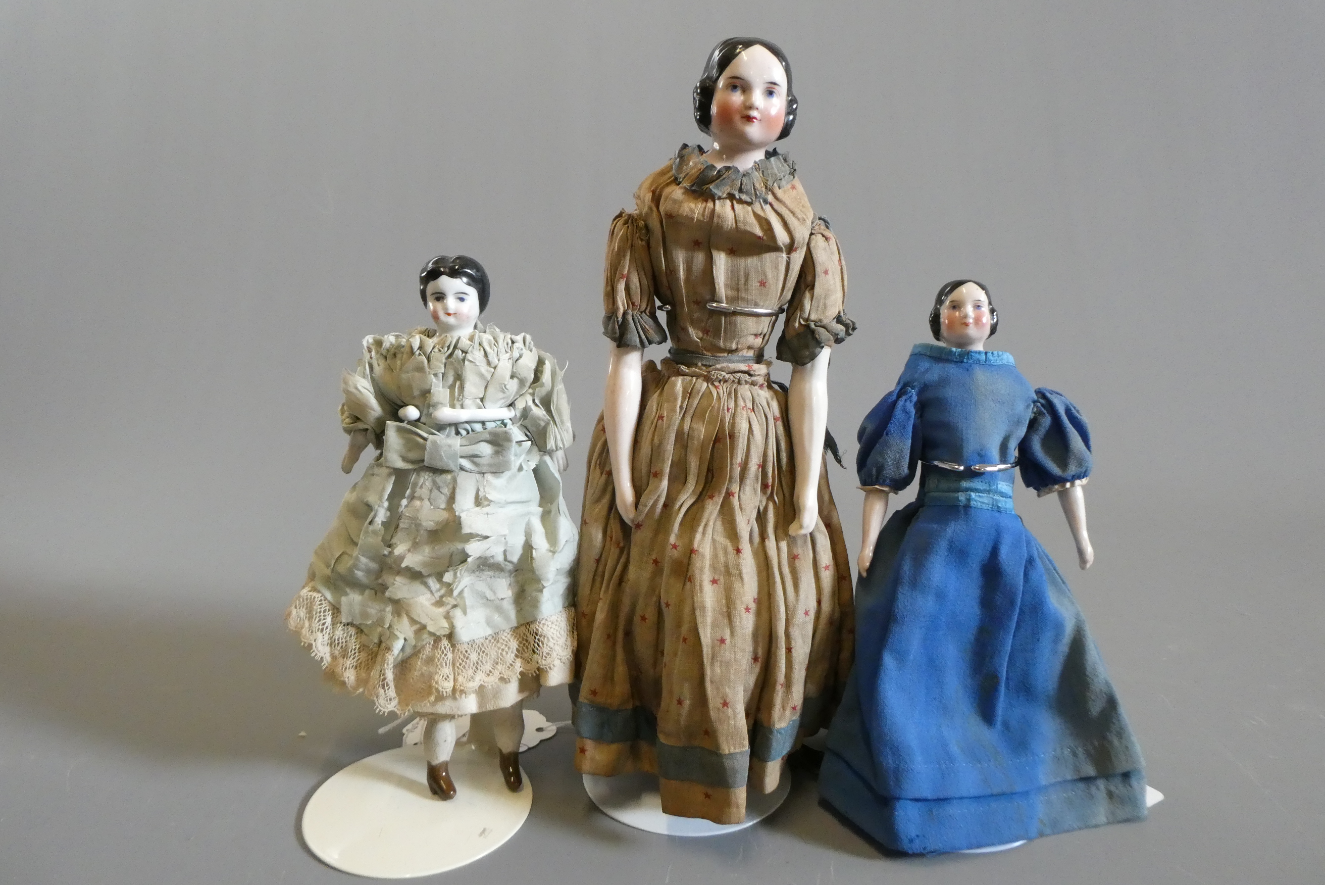 Three Victorian china shoulder head dolls Image