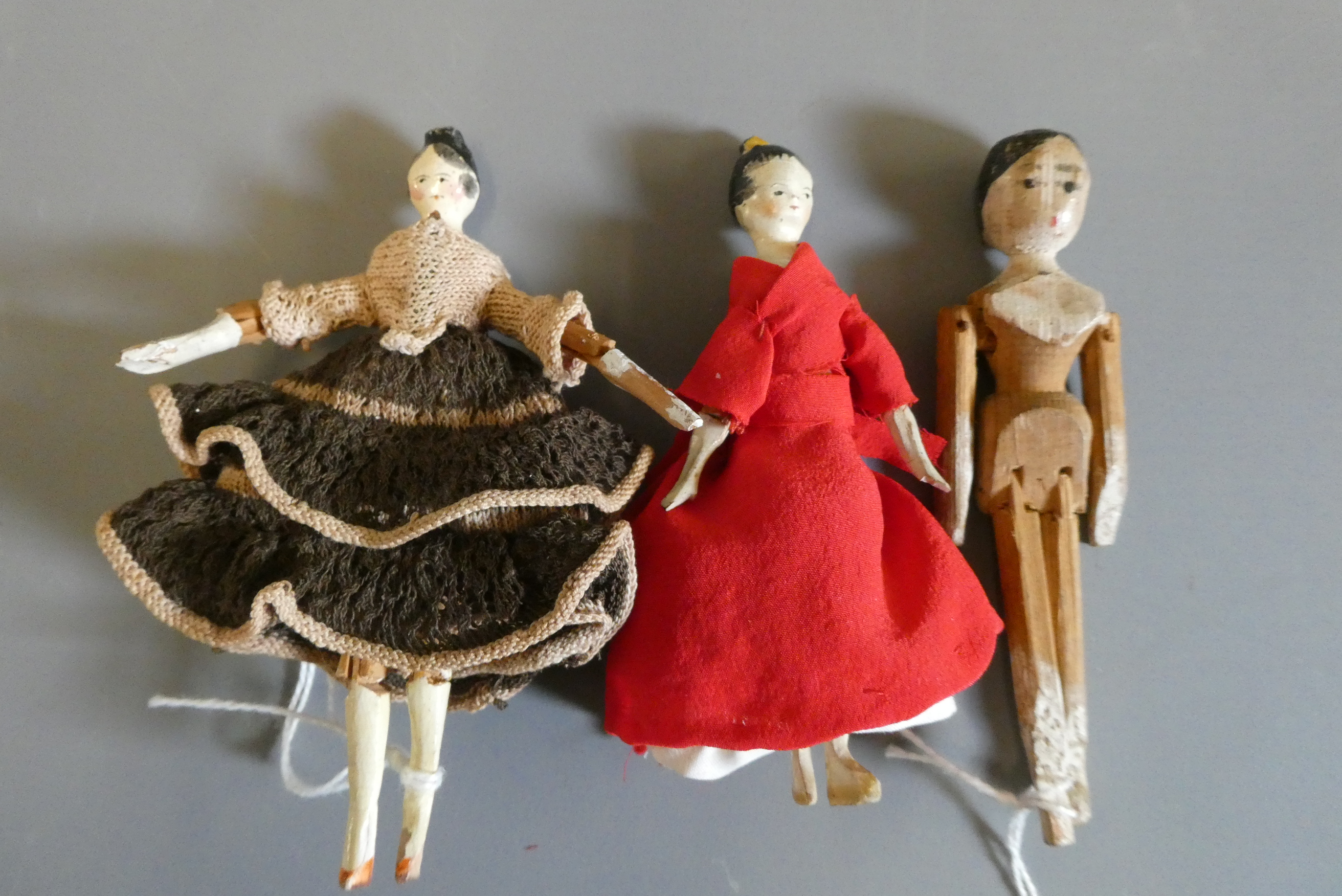 Three small peg dolls Image