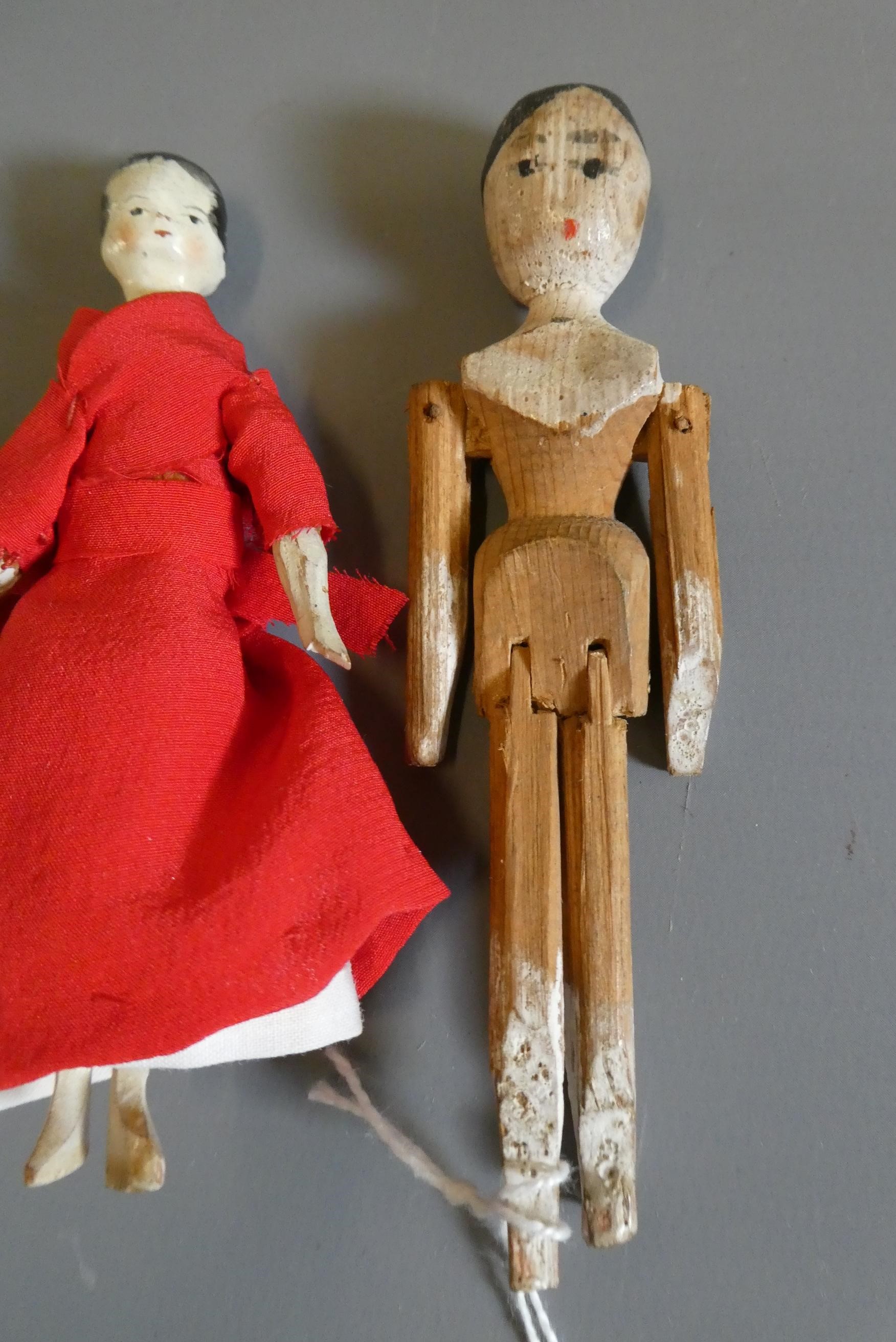 Three small peg dolls Image