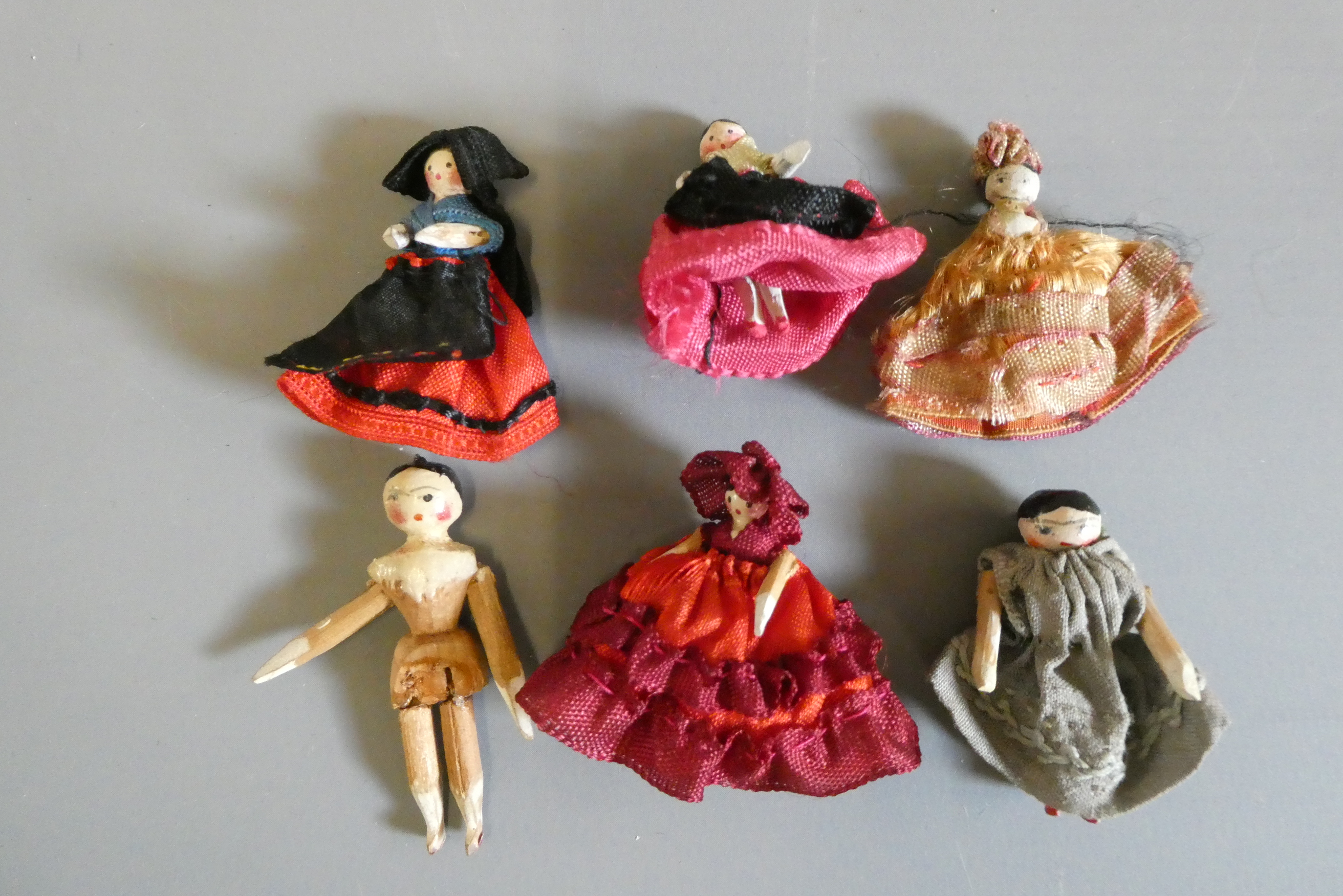 Six miniature doll's house peg dolls, all wood construction with painted features and jointed Image