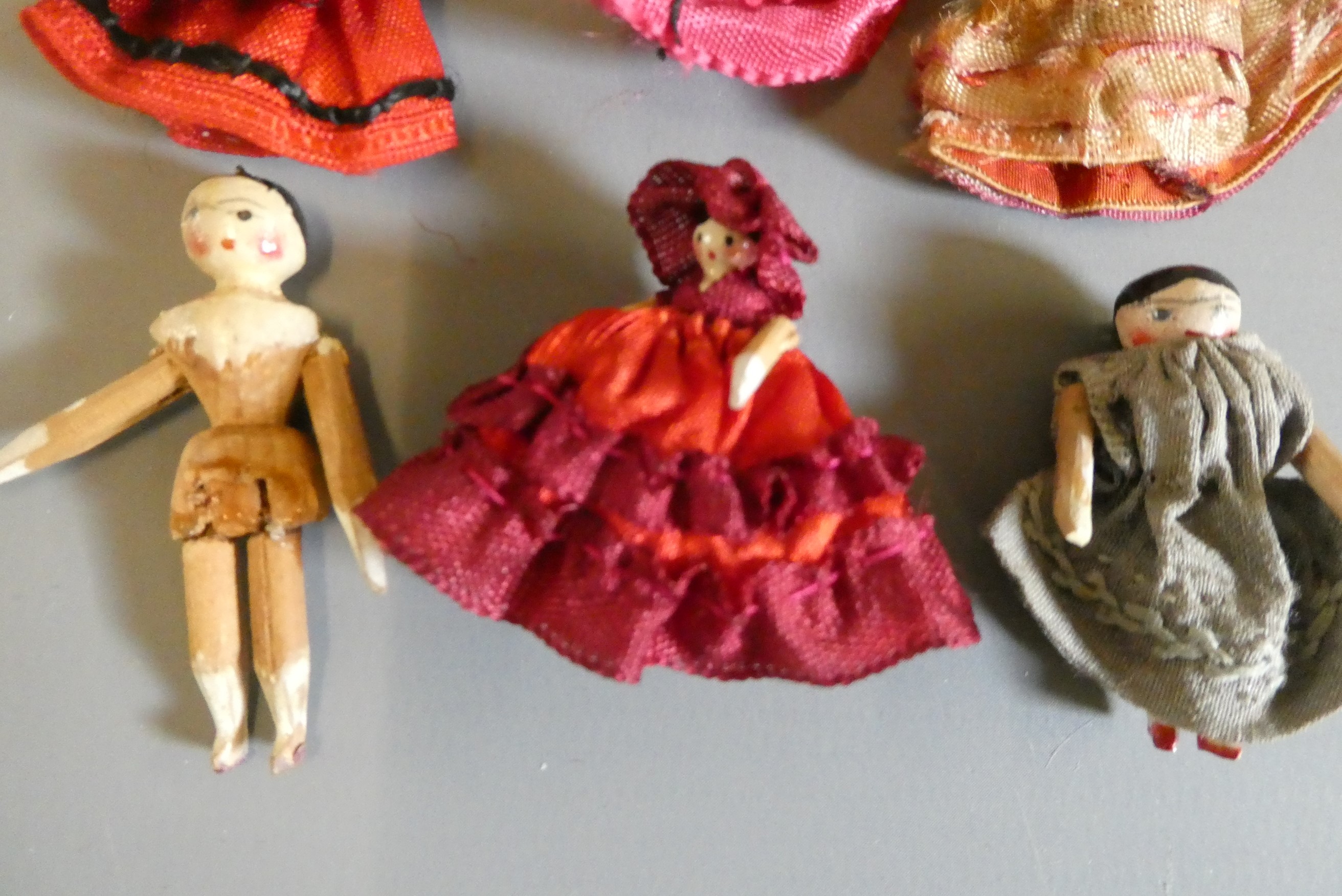 Six miniature doll's house peg dolls, all wood construction with painted features and jointed Image