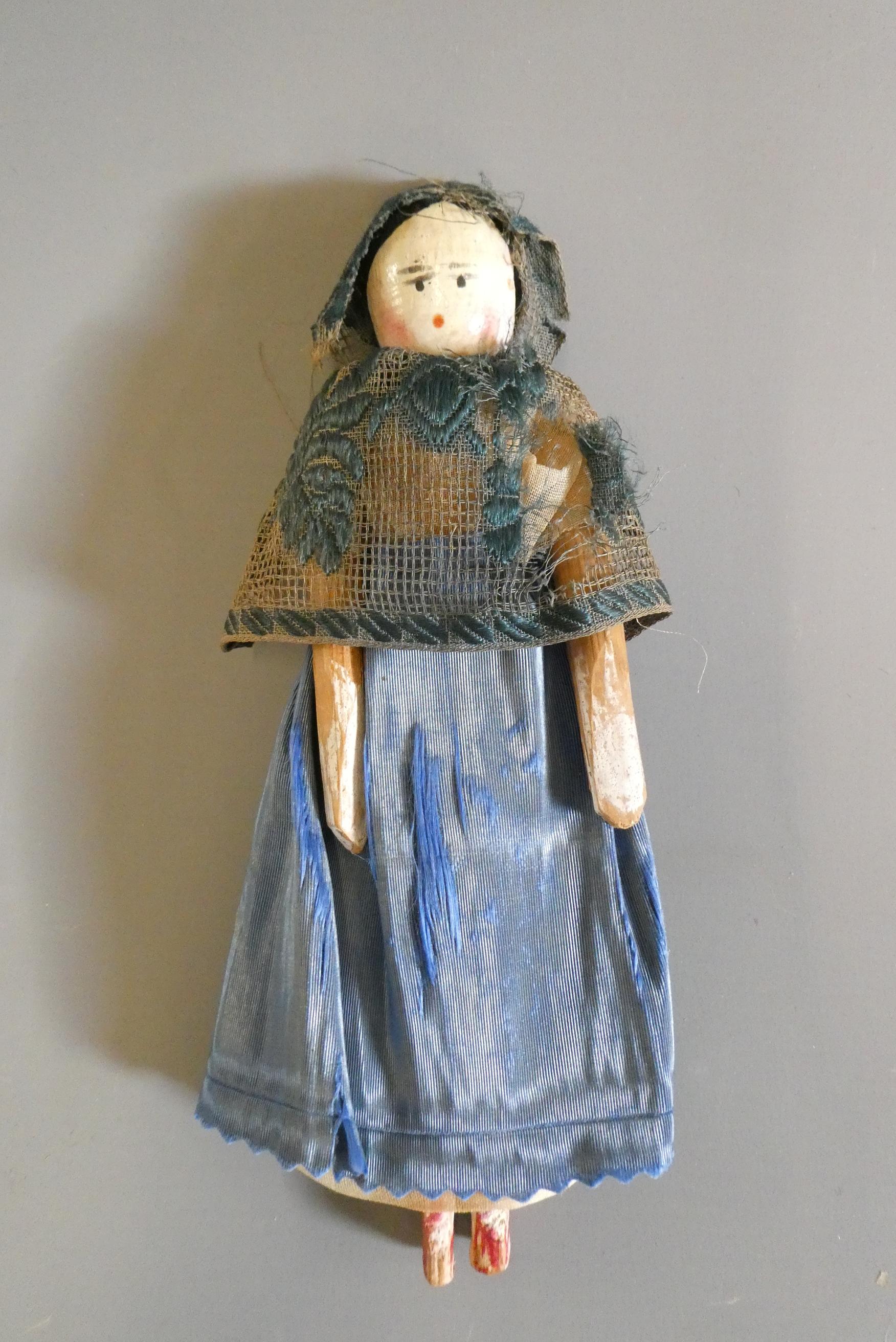 A Victorian peg doll of carved would construction, with painted features, jointed shoulders and Image