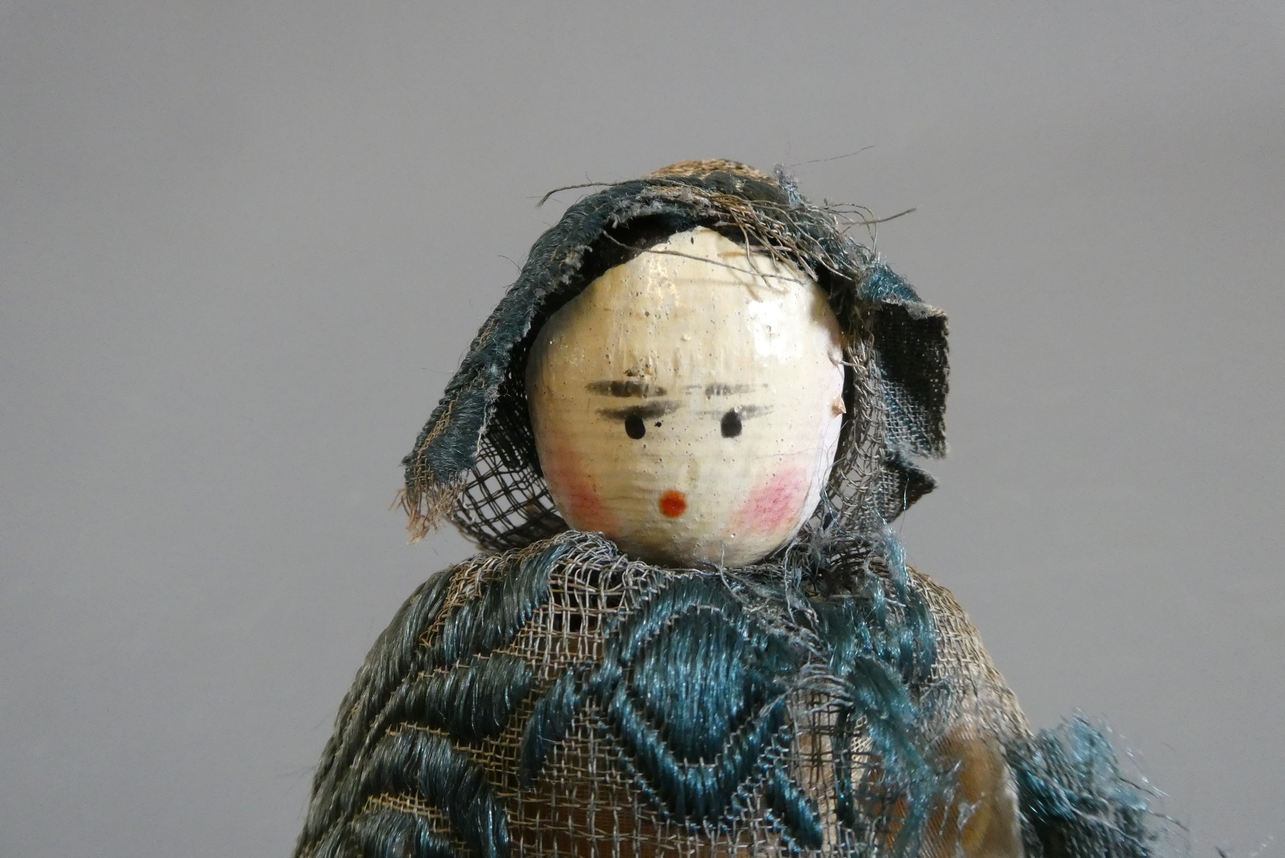 A Victorian peg doll of carved would construction, with painted features, jointed shoulders and Image