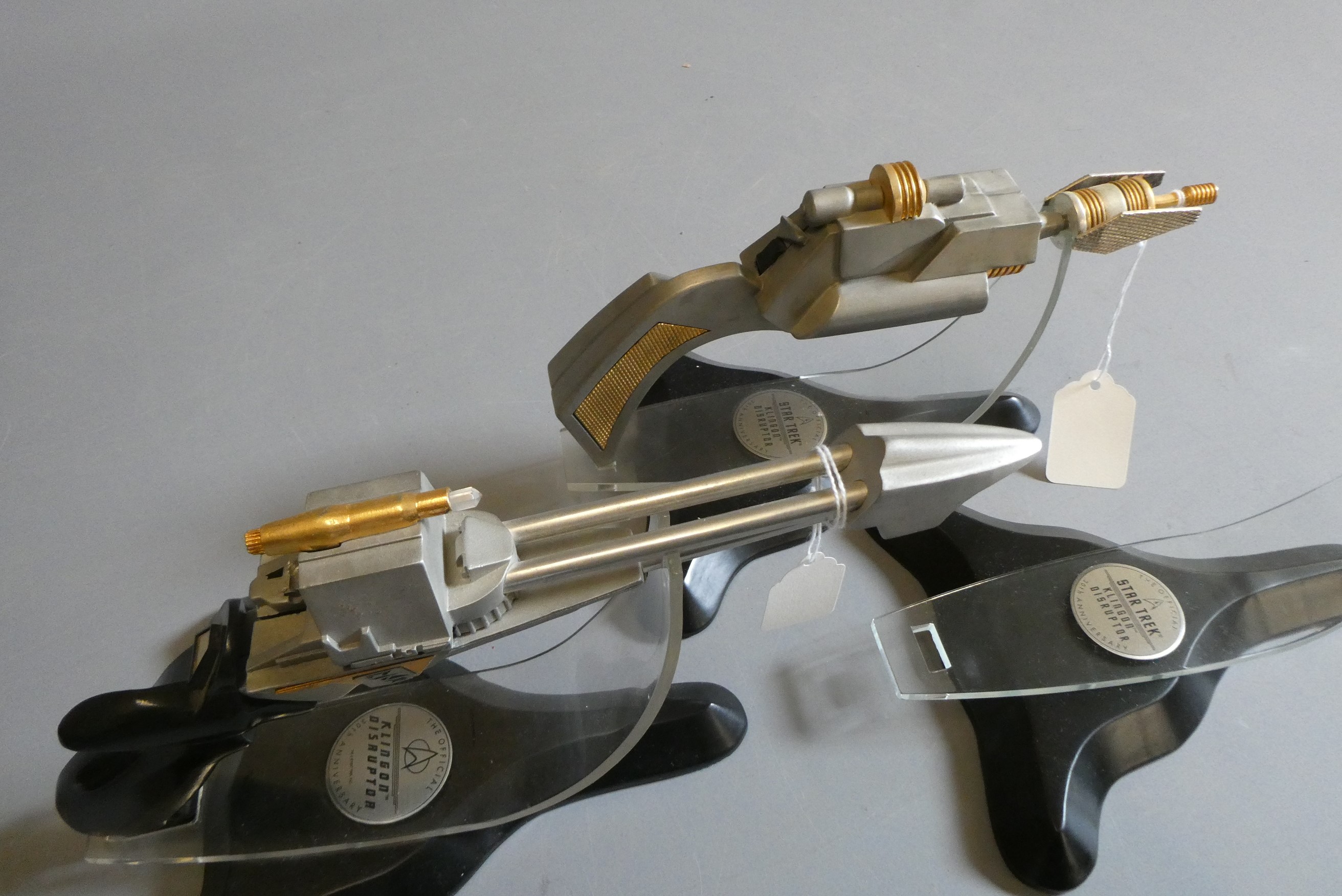 Star Trek - two Franklin Mint 30th anniversary Klingon Disruptors on stands, black handle slightly Image