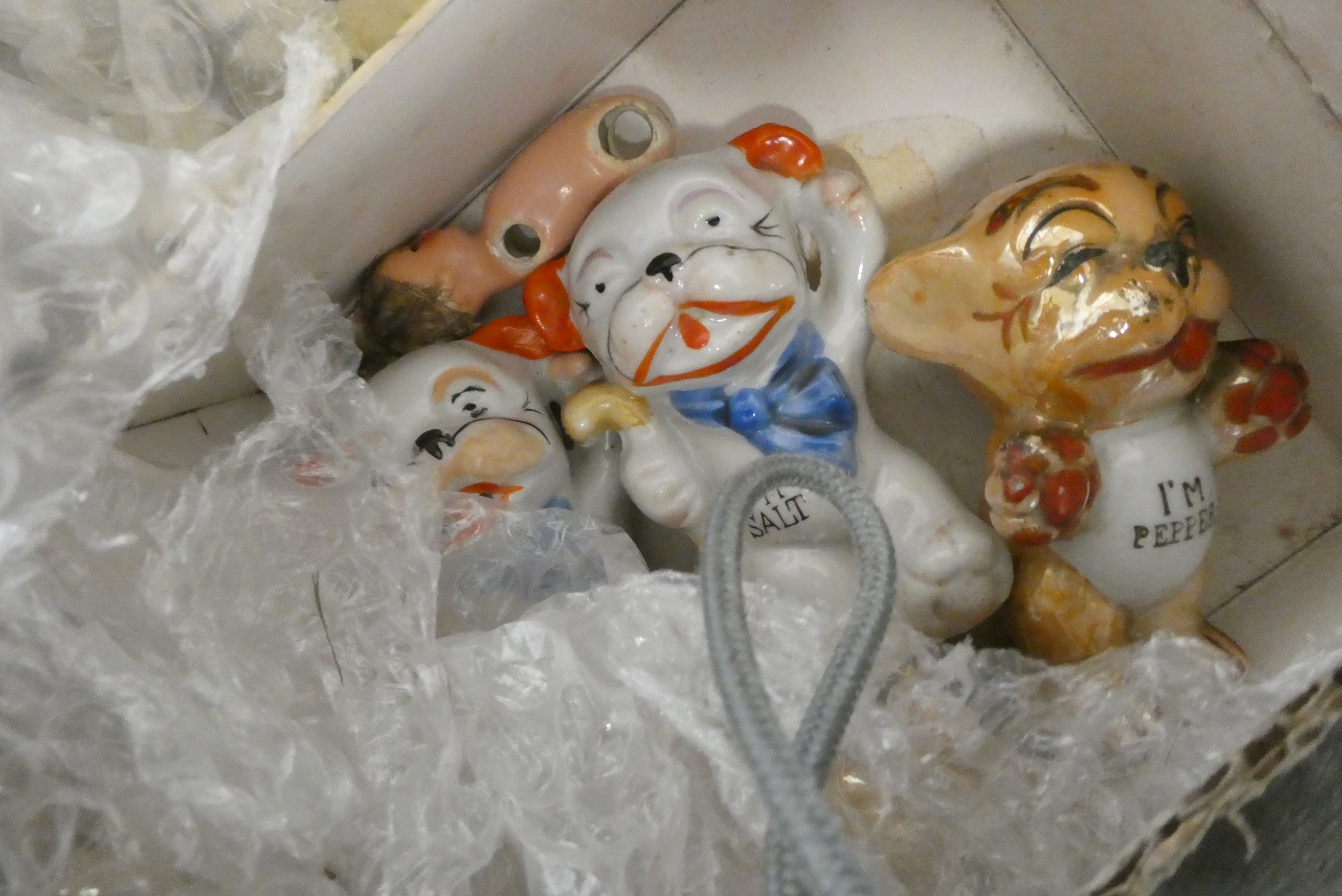 A boxed filled with vintage and antique toys, including Bonzo salt and pepper, Dismal Desmond pot, a Image