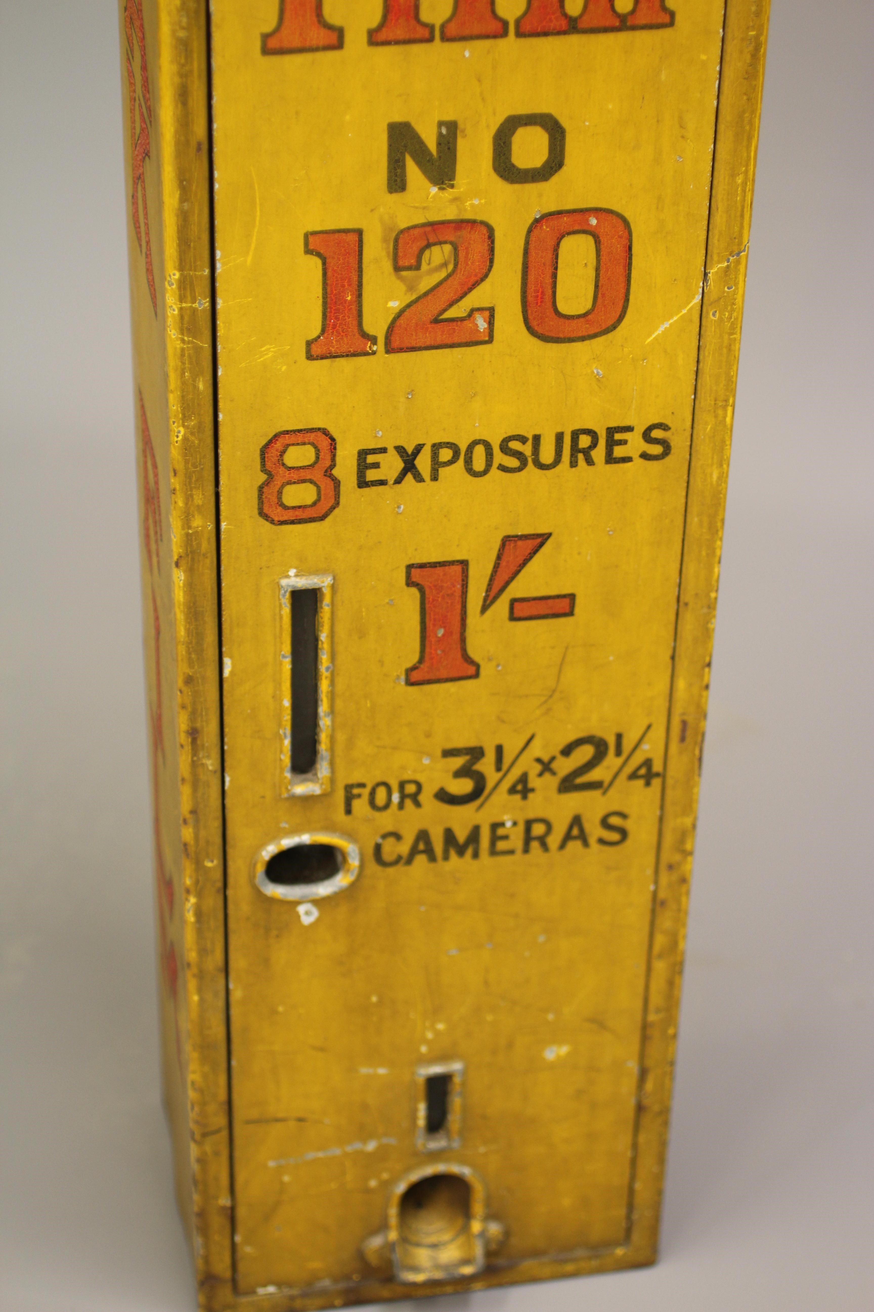 A Kodak film dispenser, 1940s, of metal construction painted yellow with red script, priced at 1/-, Image