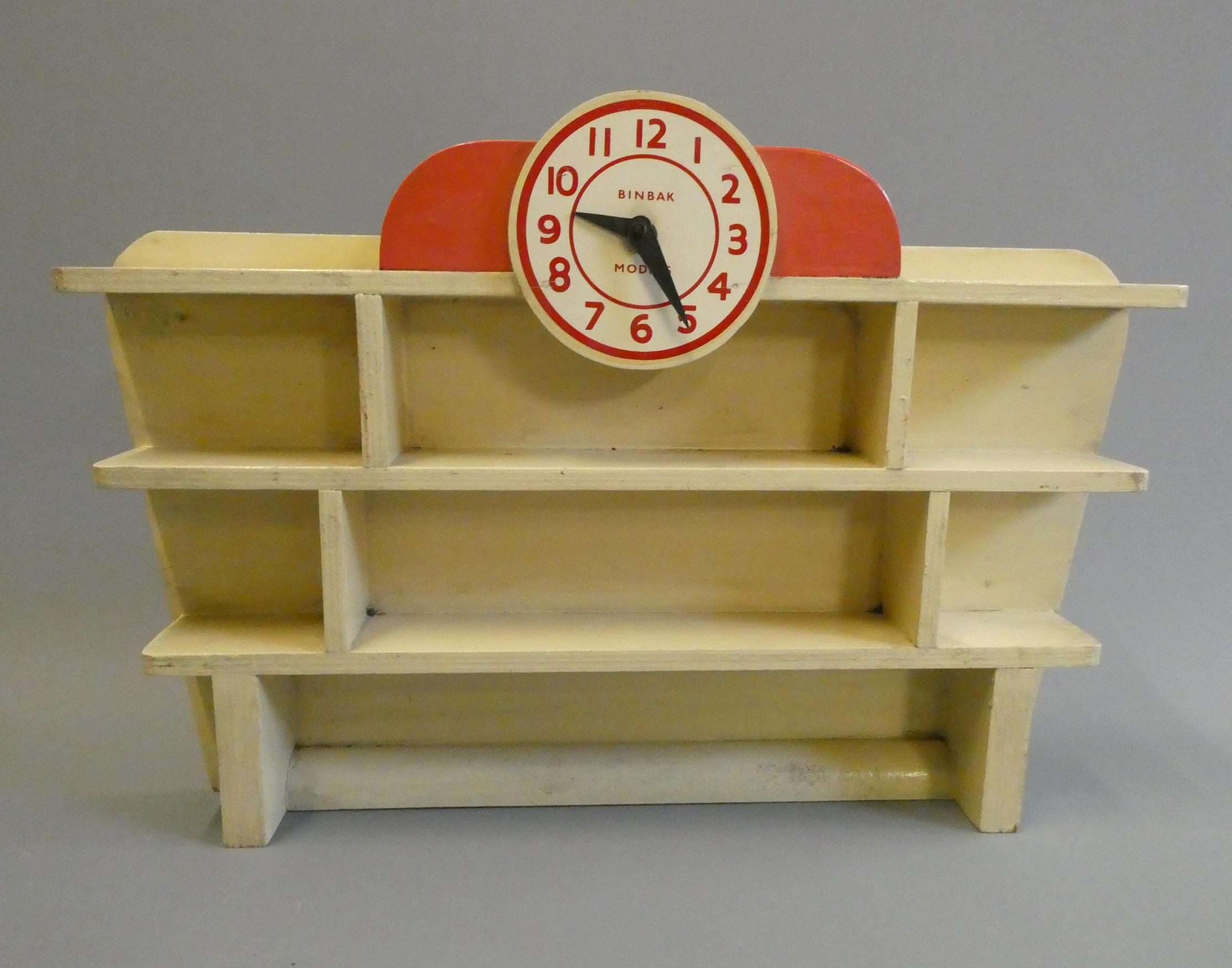 Binbak Models wooden toy car display stand with clock motif, finished in red and cream, good (Est. Image