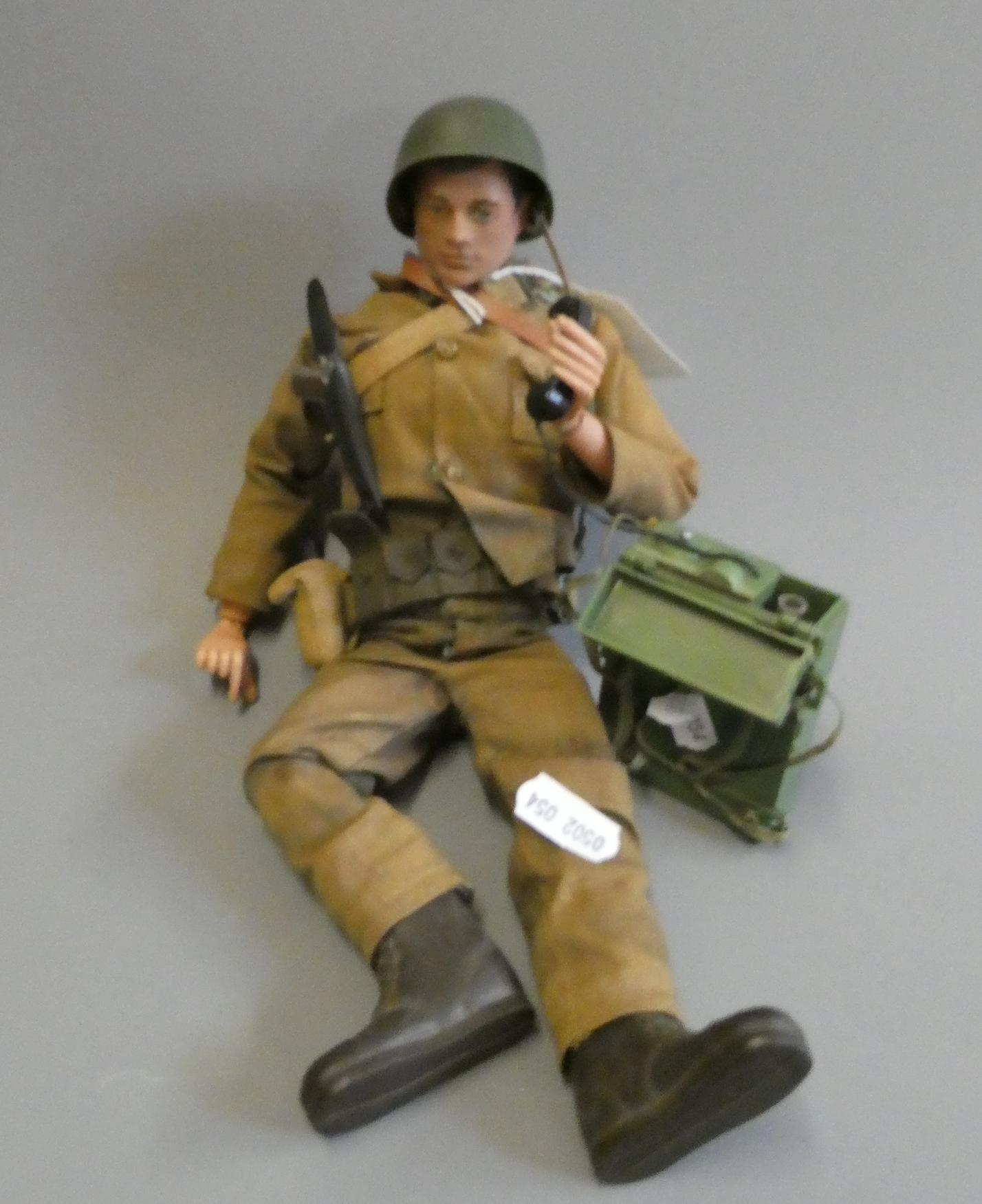A first edition Action Man doll with army uniform and radio backpack, fair (Est. plus 24% buyer's Image