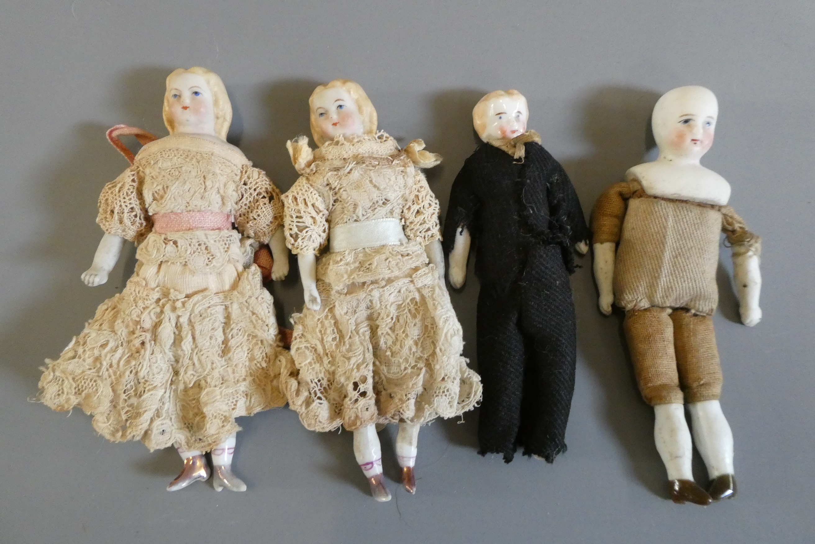 A pair of bisque shoulder head dolls with moulded and painted features Image
