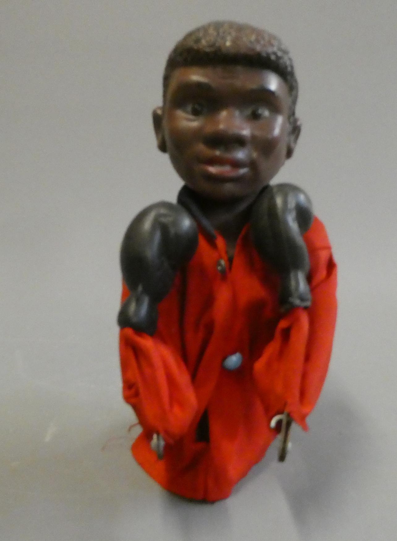 Boxer puppet with boxing action arms with a look of a very young Mohammed Ali. Some wear and holes Image